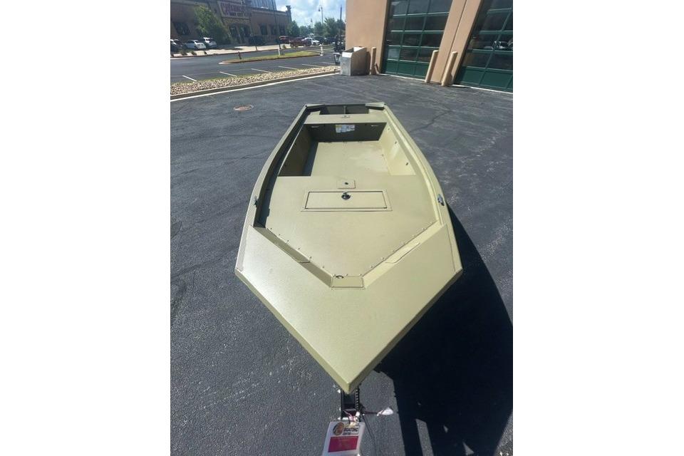 2026 Tracker Grizzly 1648 Utility boat in a parking lot, showcasing its sturdy design.