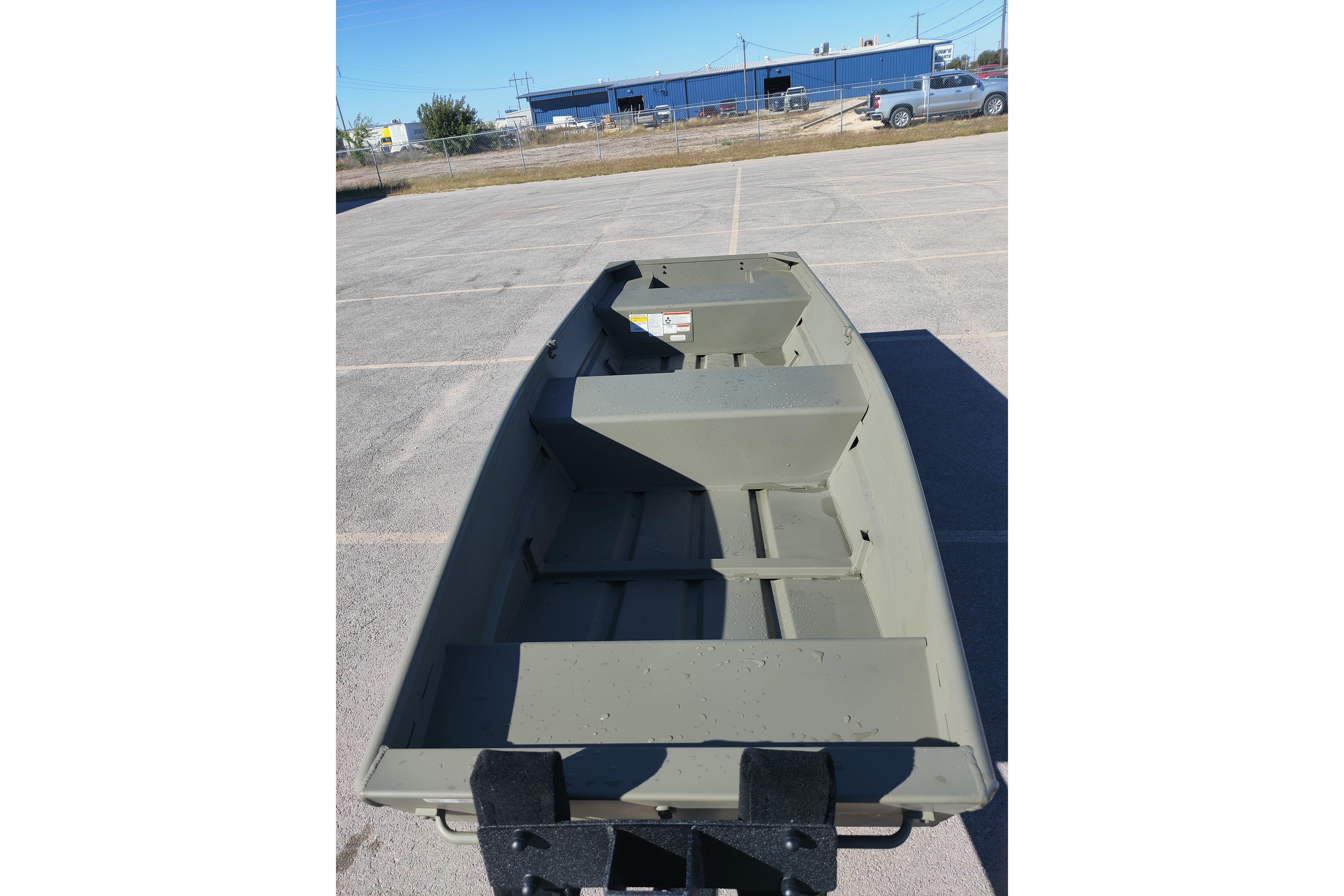 2026 Tracker Grizzly 14 Jon boat in a parking lot, showcasing interior layout.