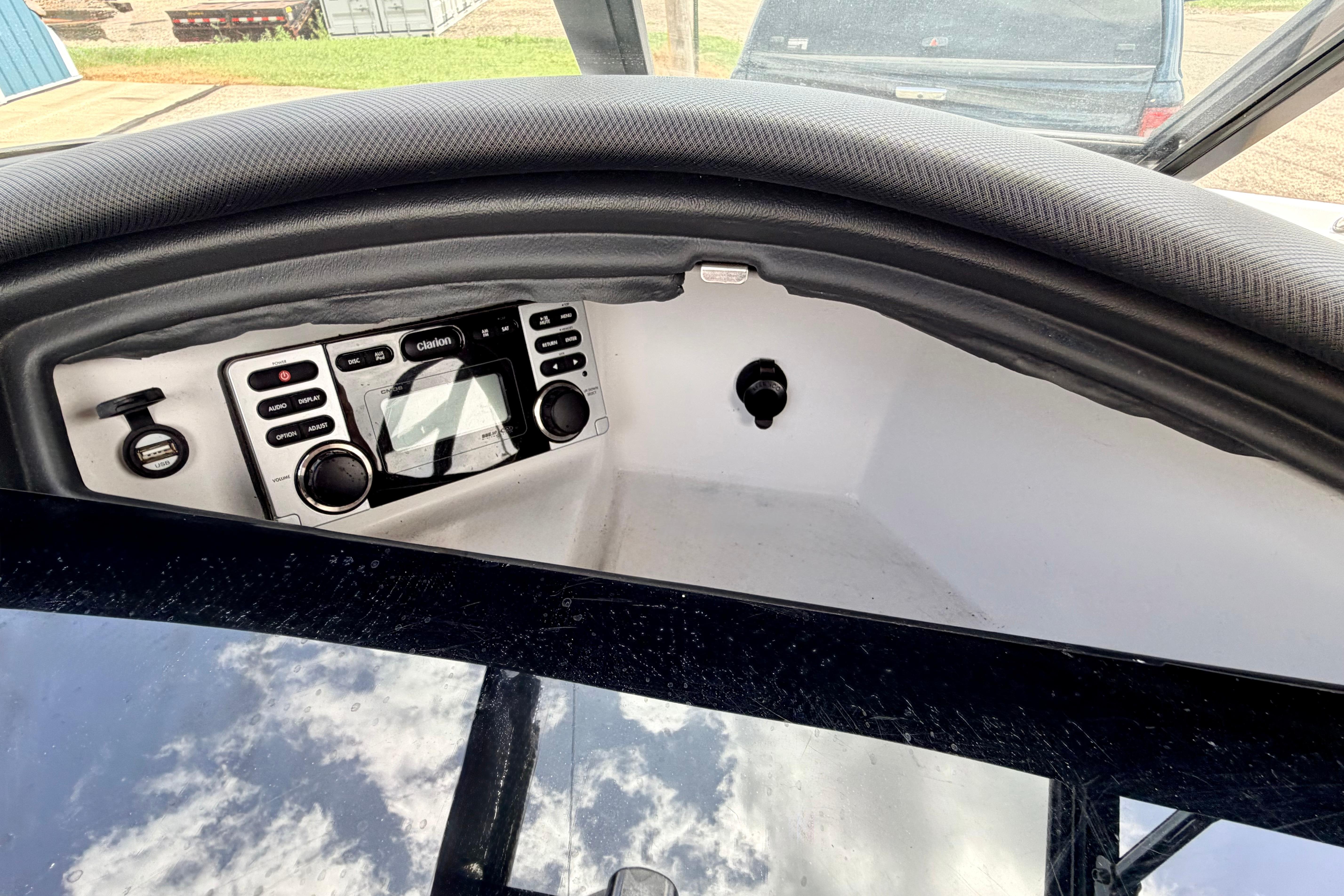 2014 Tigé R20 boat dashboard with Clarion audio system and control panel.