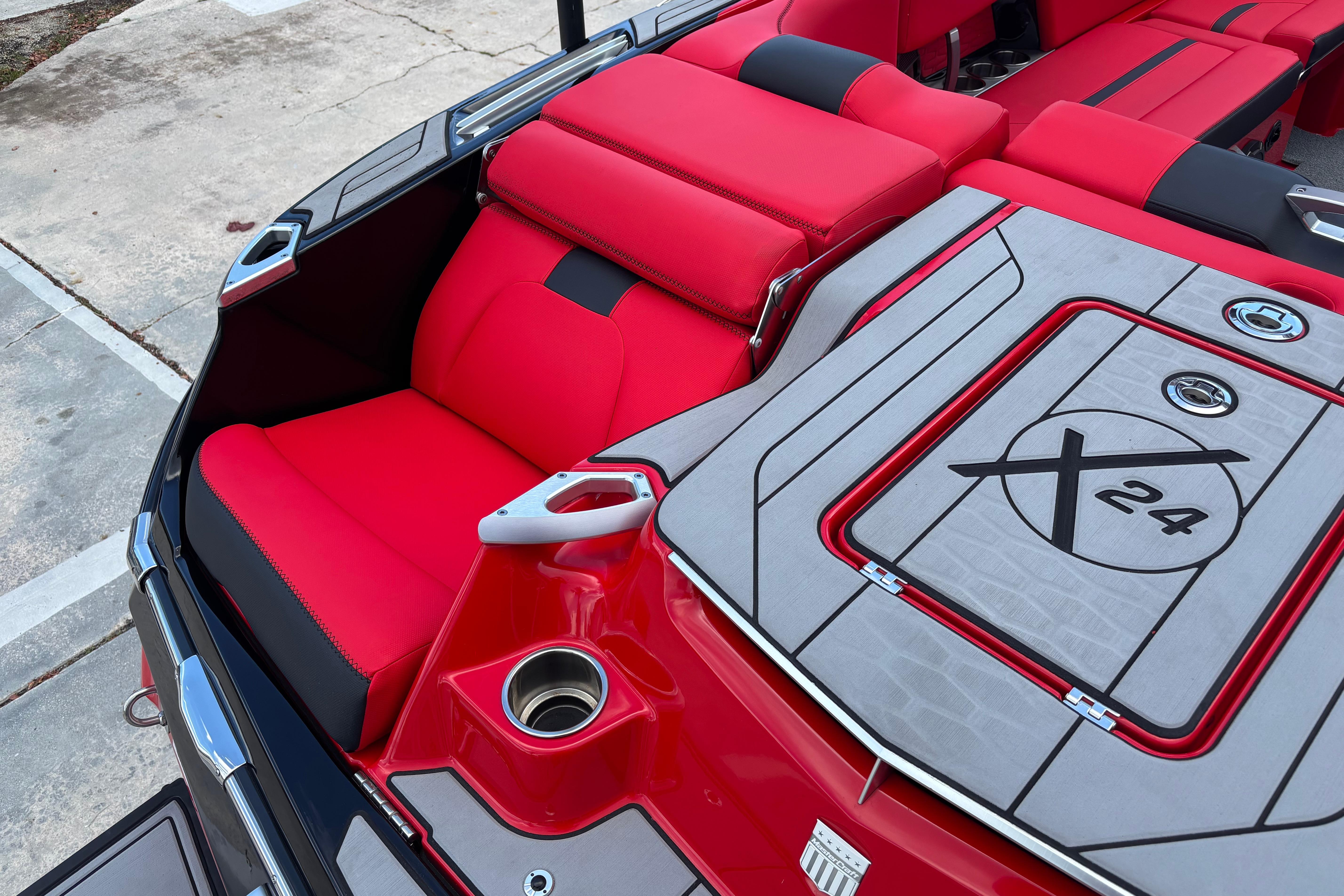 2020 MasterCraft X24 boat interior with red seating and sleek design.