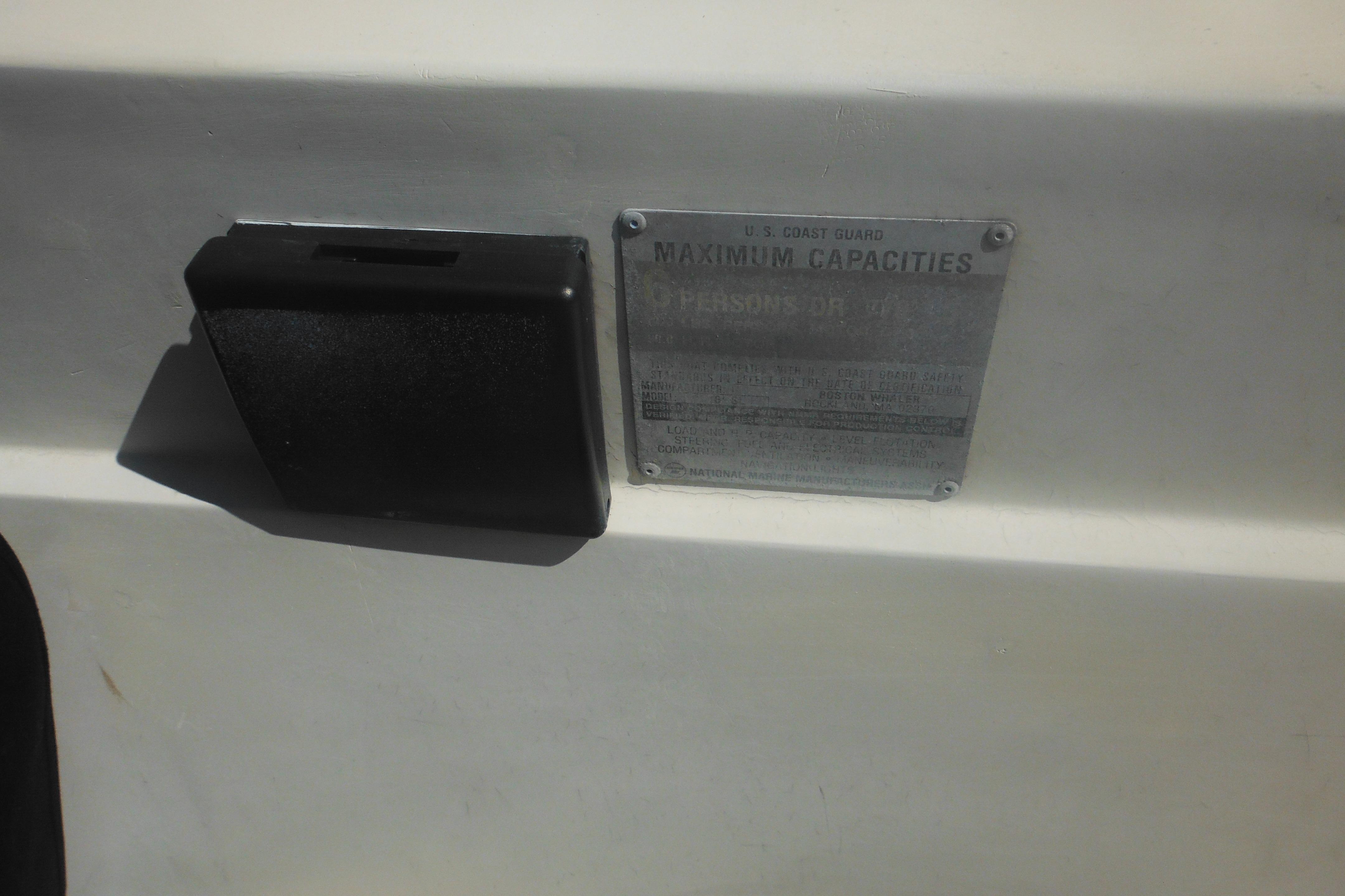 1991 Boston Whaler 16 SL boat capacity plate, showing maximum persons or weight limit.