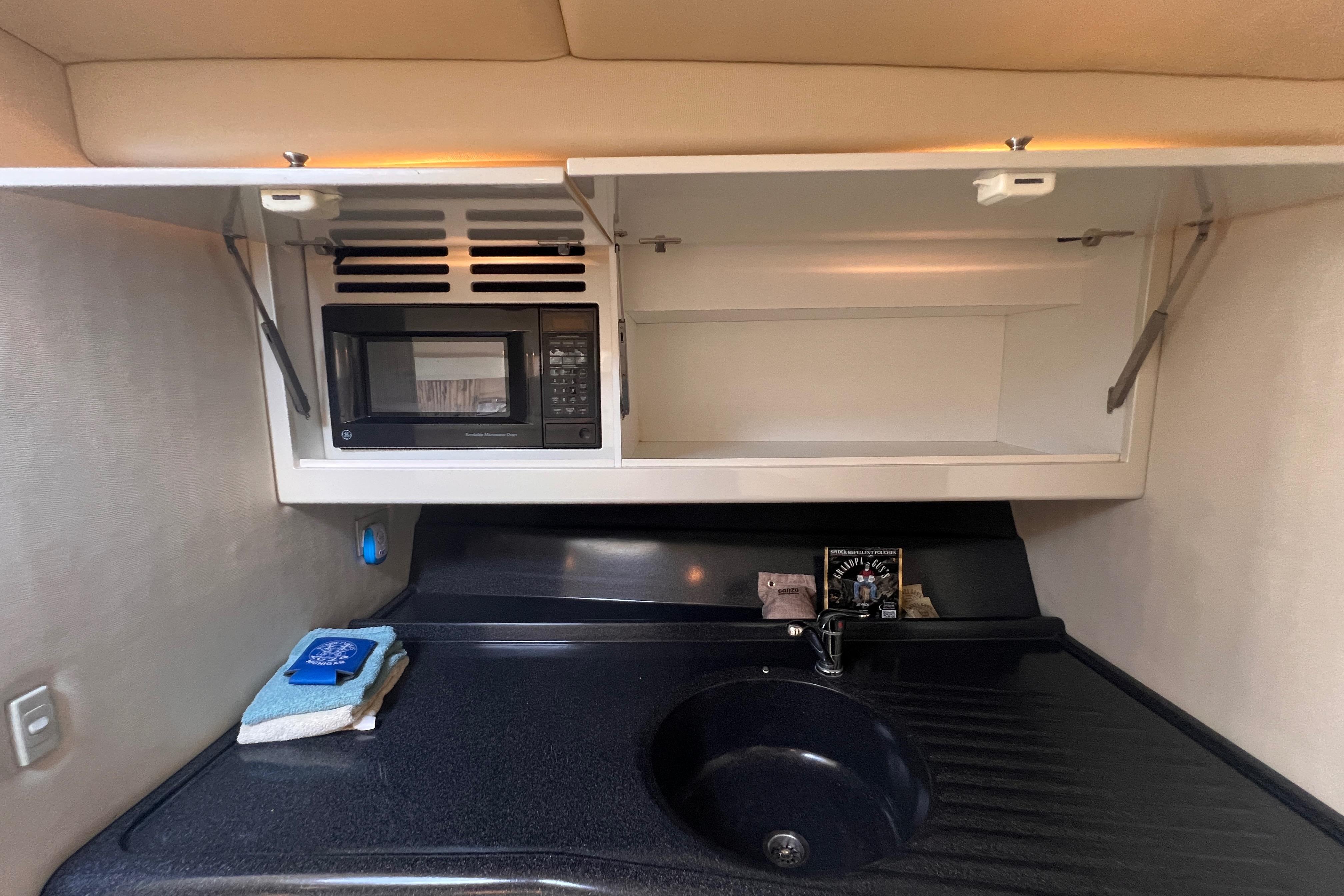 Wellcraft 45 Excalibur 2000 interior kitchen with microwave and sink.