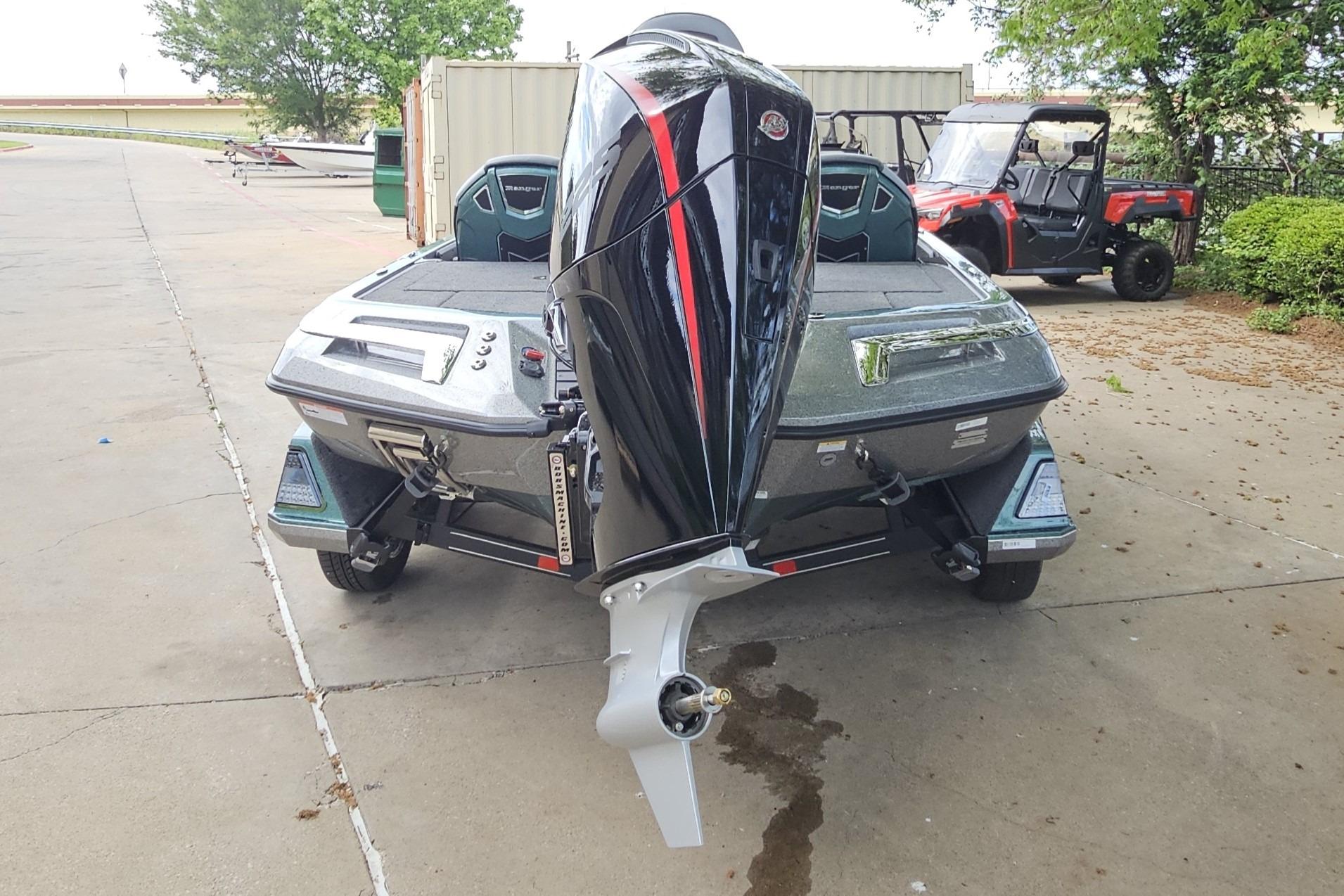 2026 Ranger Z519R Cup-Equipped boat with powerful outboard motor, parked outdoors.