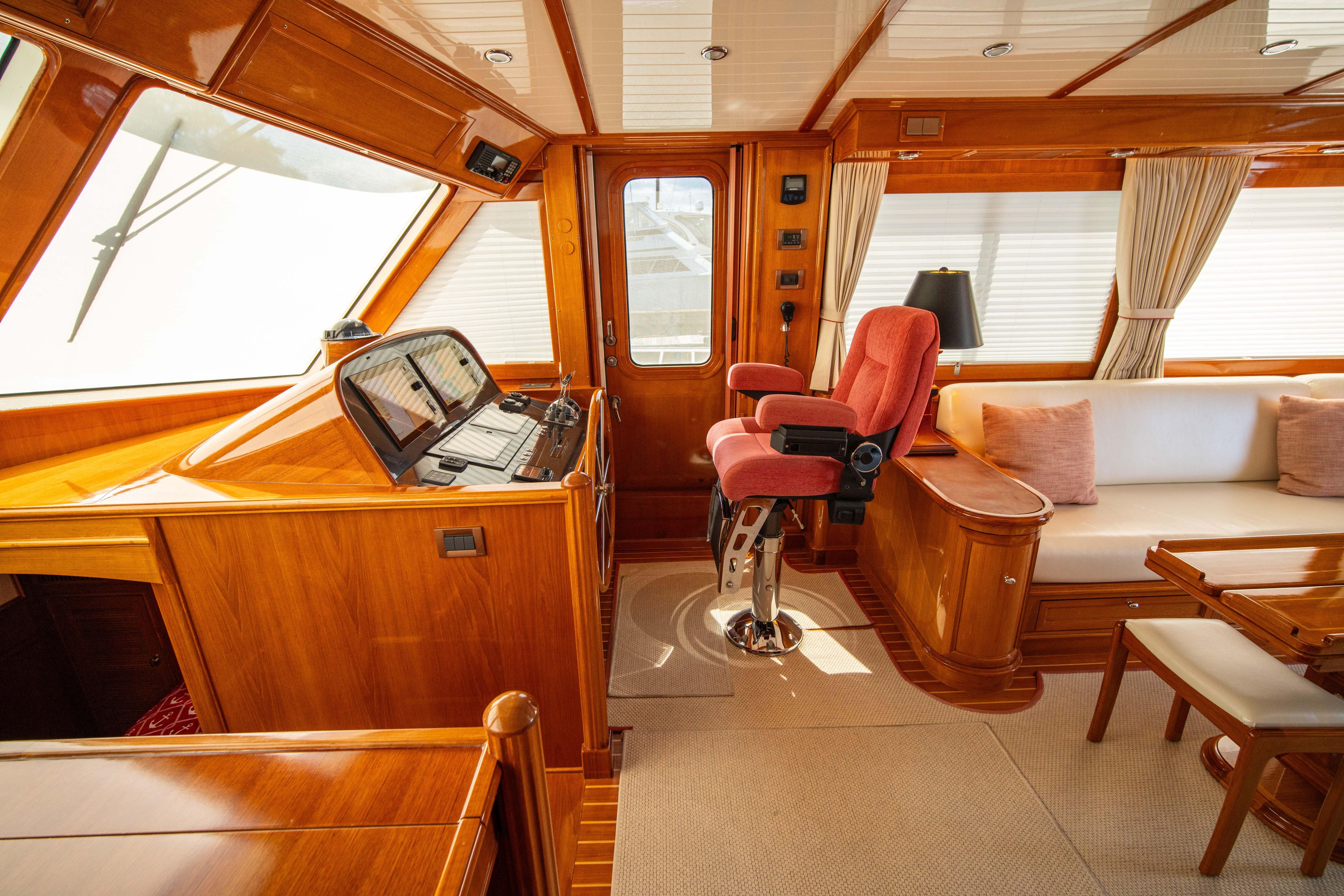 Luxurious interior of 2004 Grand Banks 58 Eastbay FB yacht with wood finish and seating.