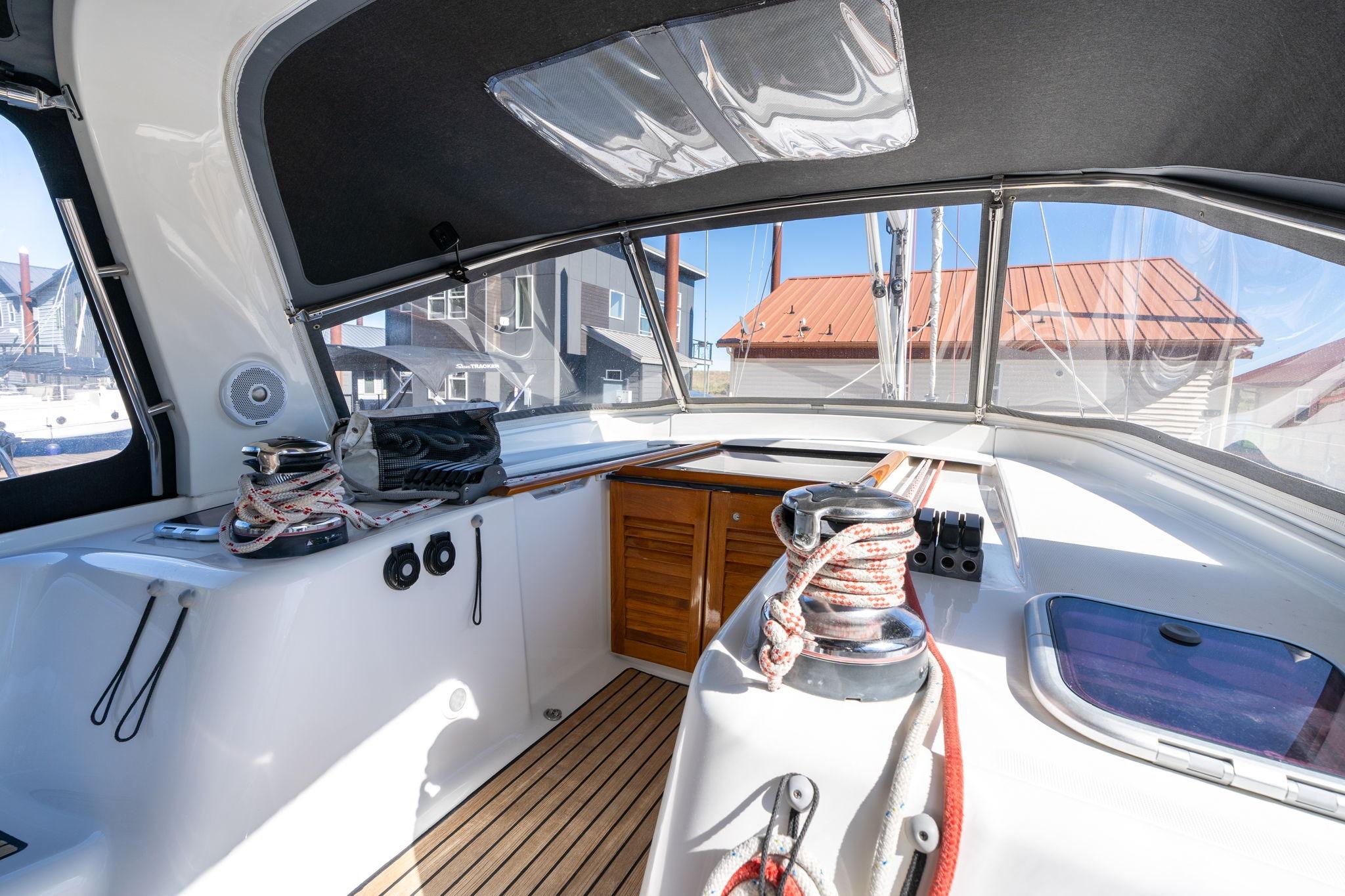 Interior view of 2013 Beneteau Oceanis 50 sailboat cockpit with winches and ropes.