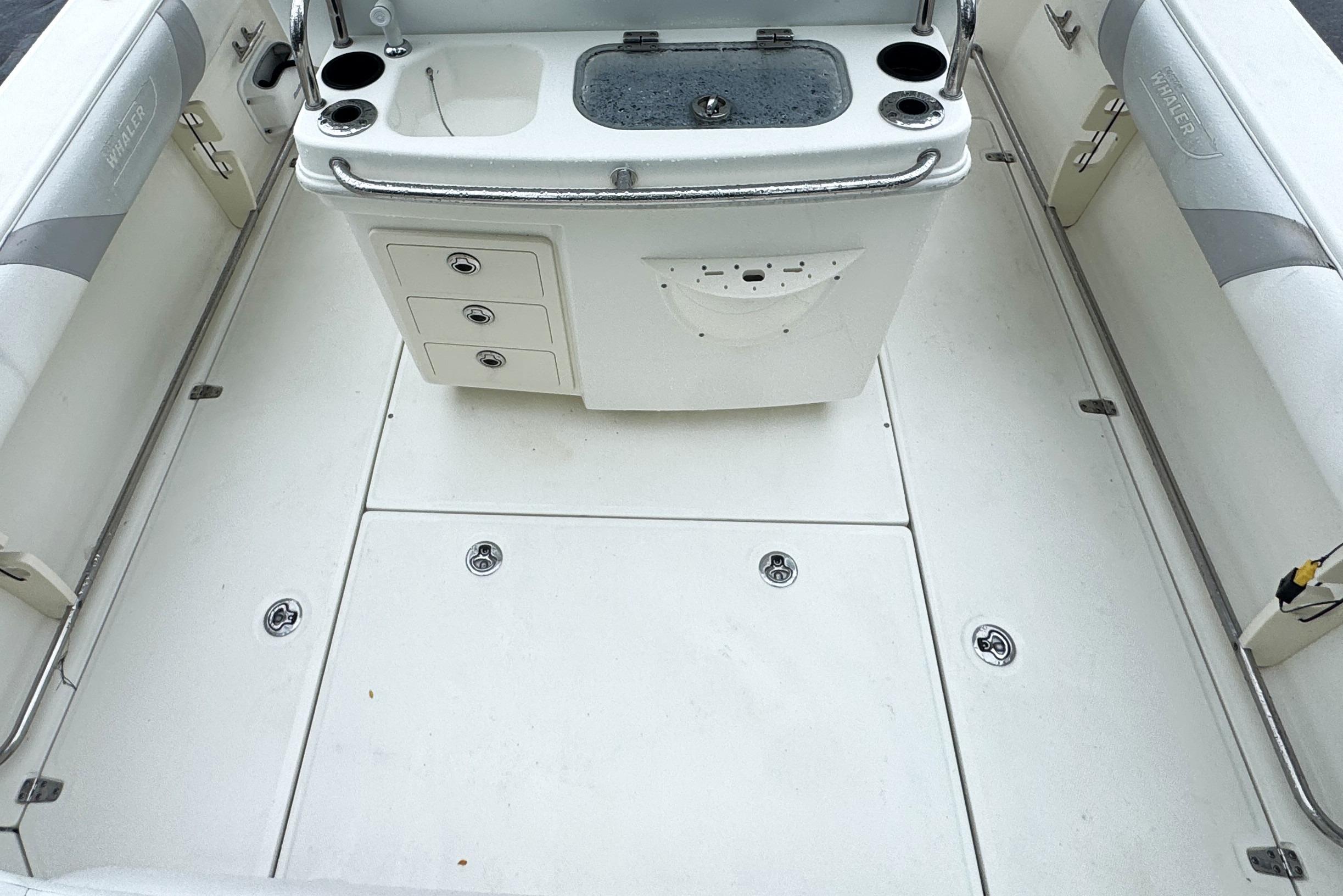 2014 Boston Whaler 250 Outrage boat deck with storage and seating.