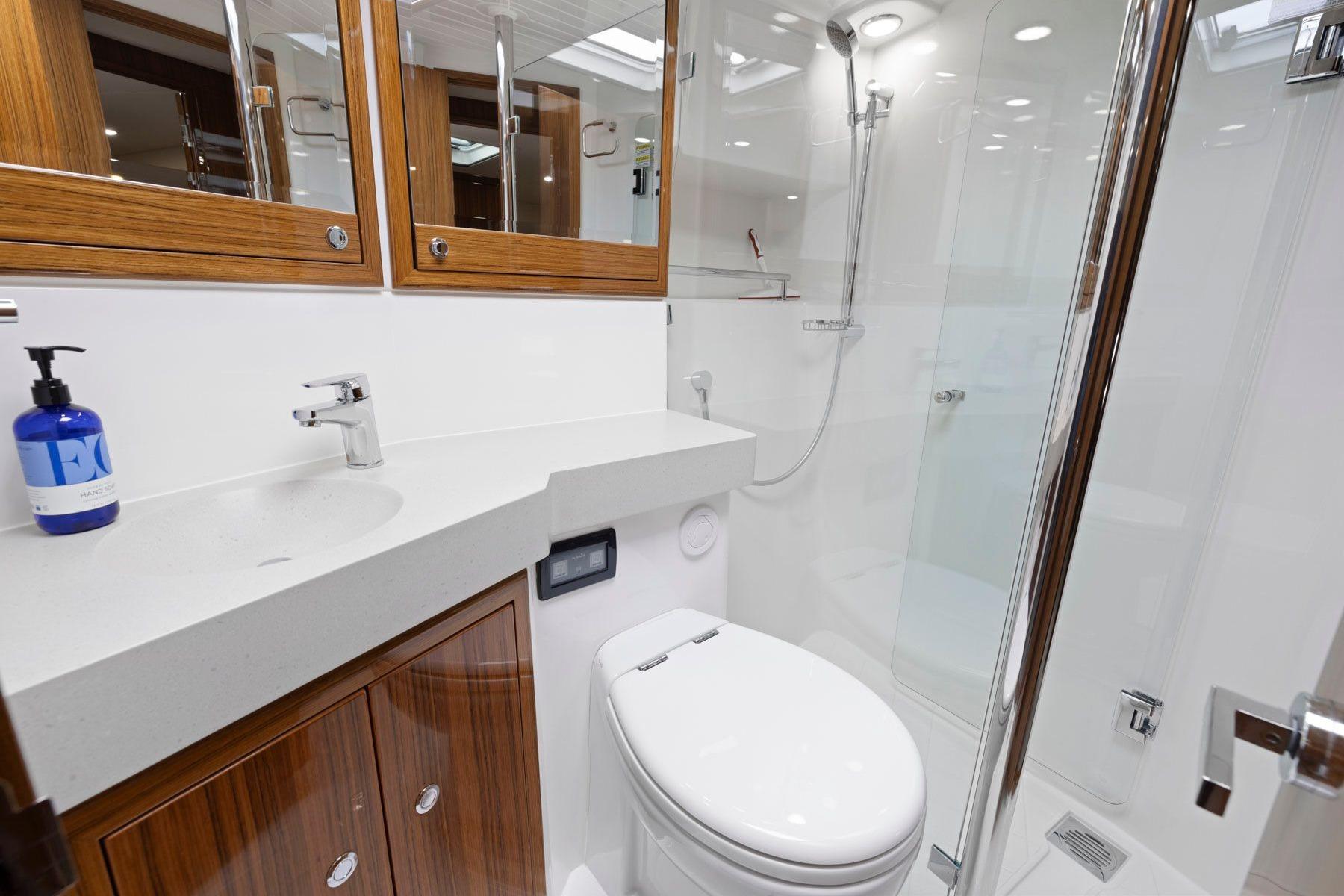Luxurious bathroom in 2014 Maritimo M50 yacht with modern fixtures and wooden accents.