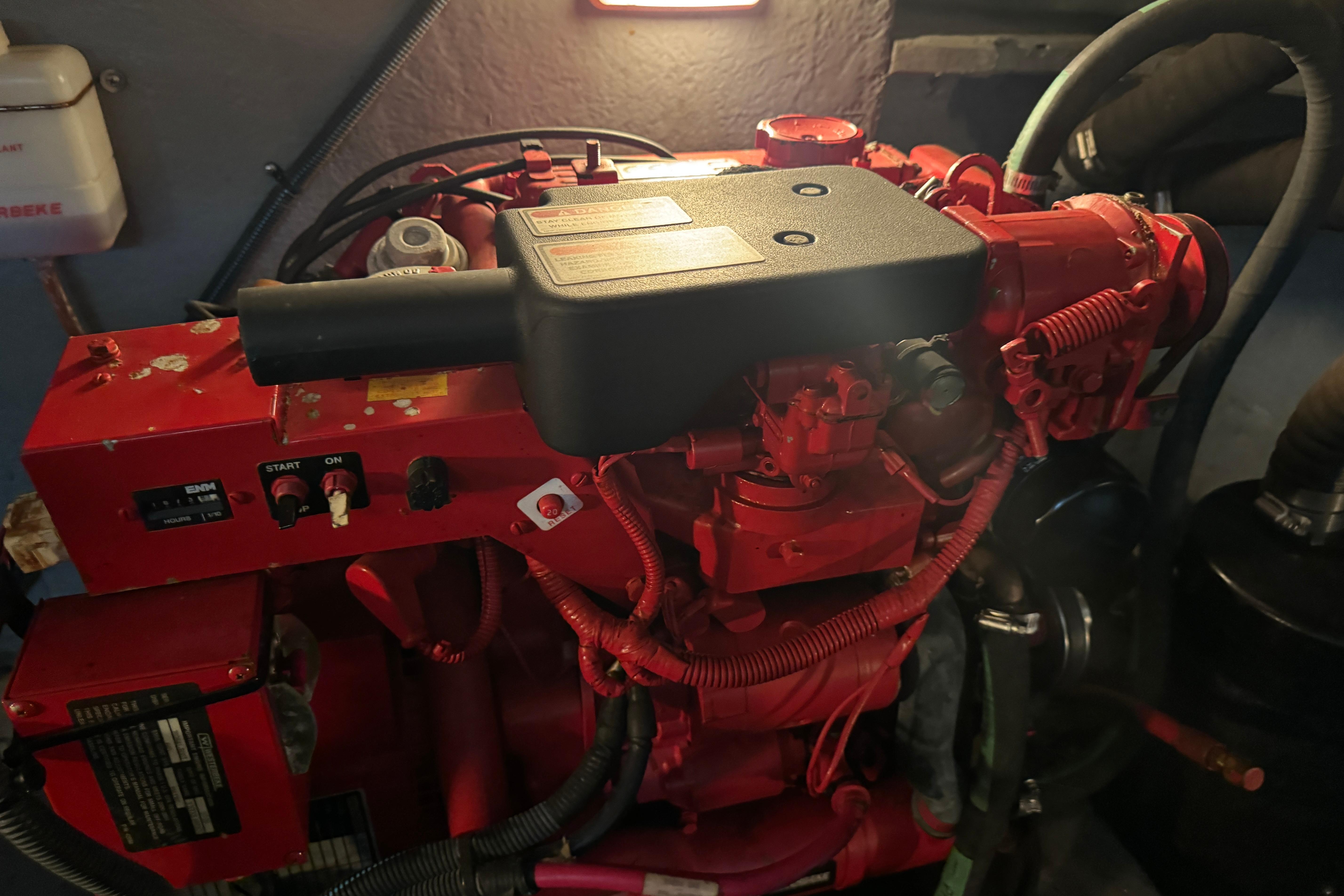 Engine room of a 2001 Sea Ray 380 Sundancer with red machinery components.