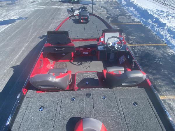2025 Nitro Z21 XL Pro fishing boat with red and gray interior, parked on snowy pavement.
