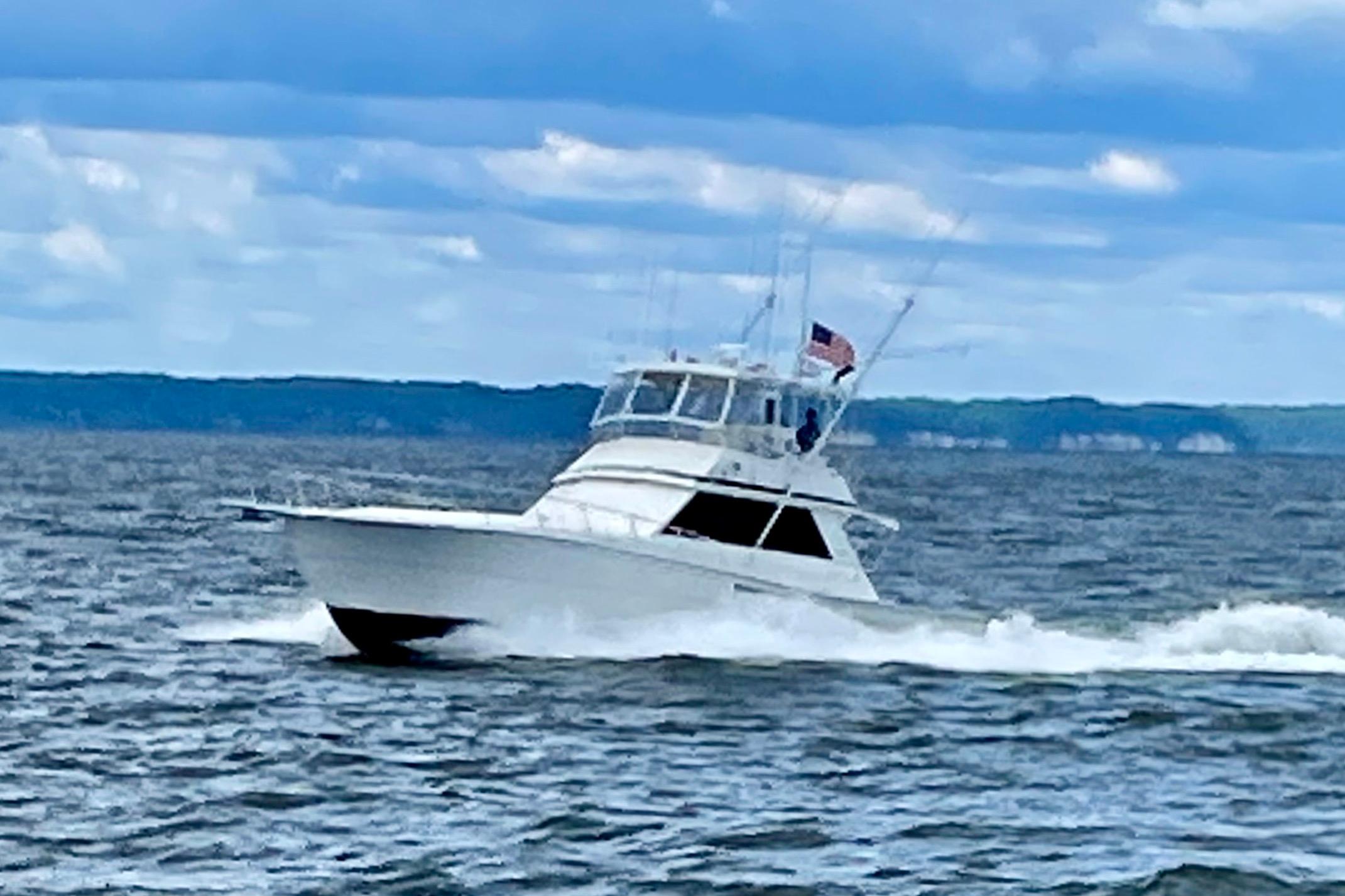 1989 Viking 48 yacht cruising on open water under a cloudy sky.