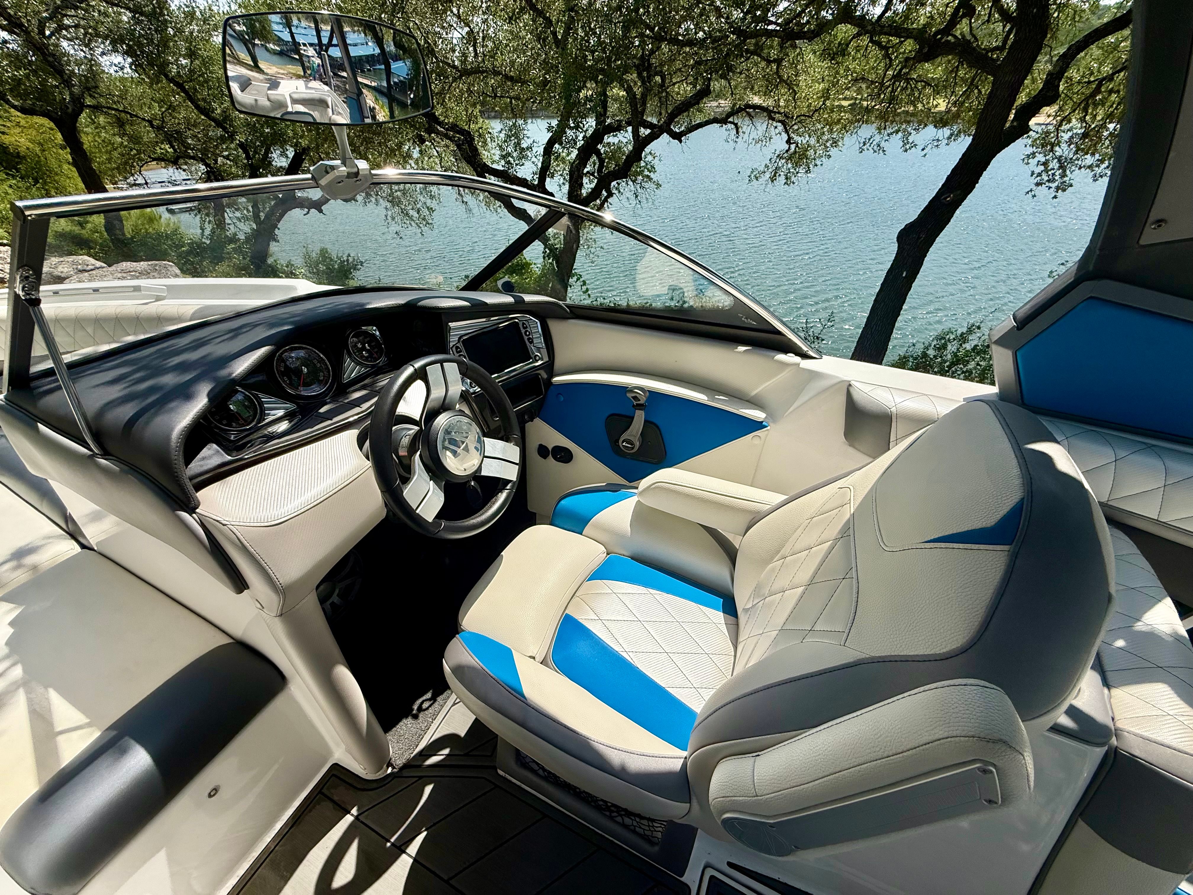 The image shows the cockpit of a 2017 Tigé Z3 boat with blue and white seats.