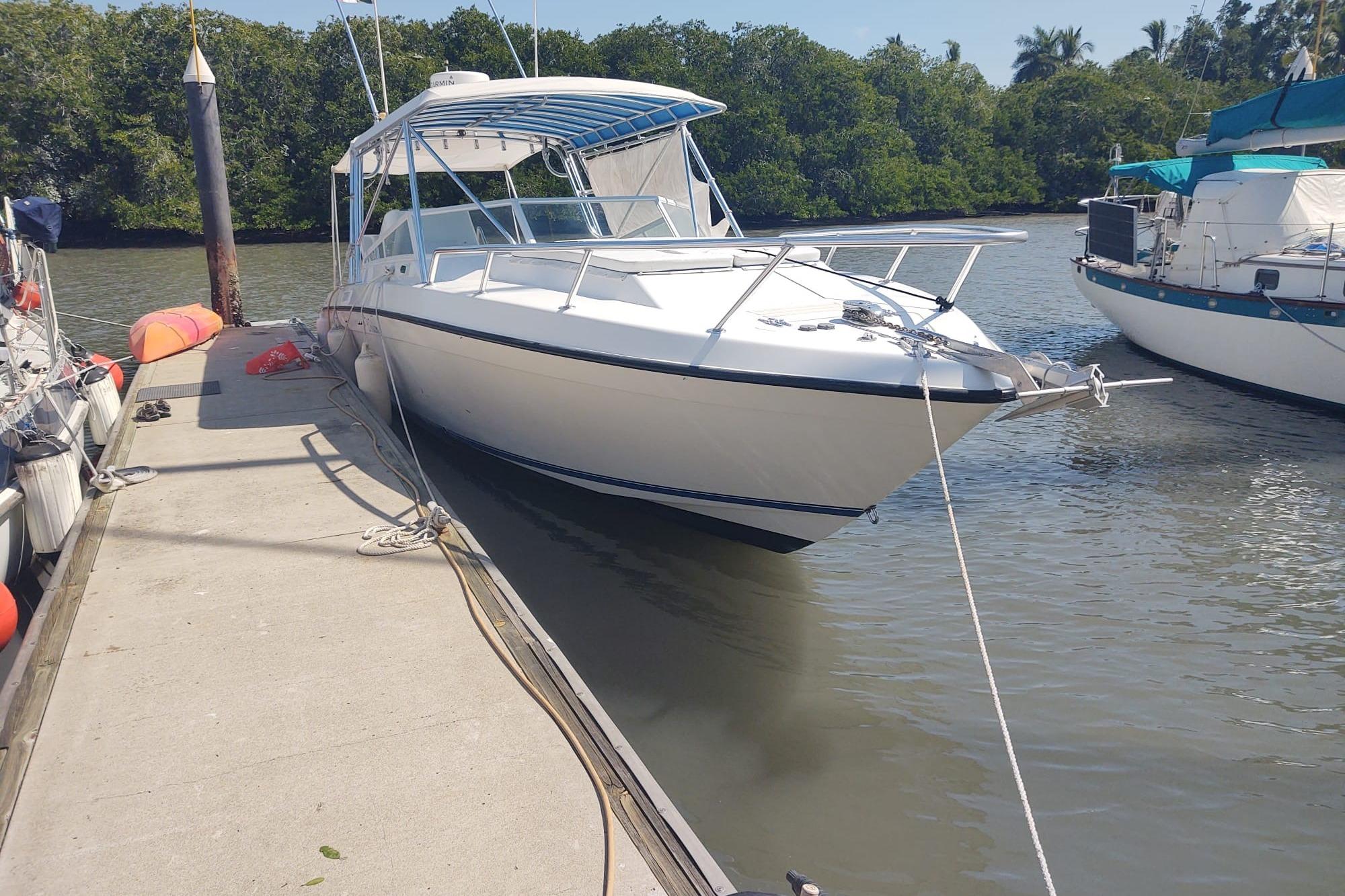 2008 Contender 35 Express Side Console boat docked by the river.