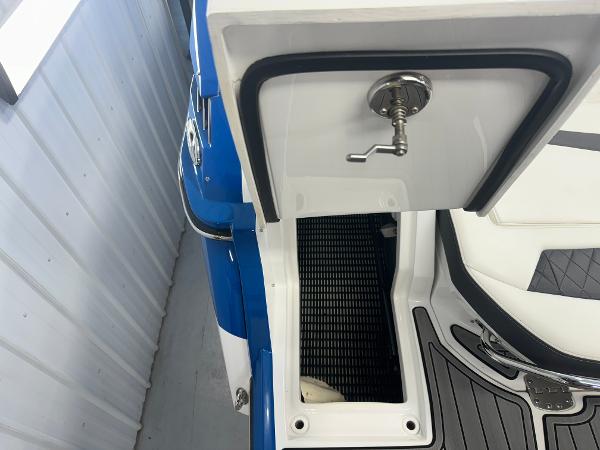 2018 Monterey 258 Super Sport boat interior with open storage compartment and faucet.