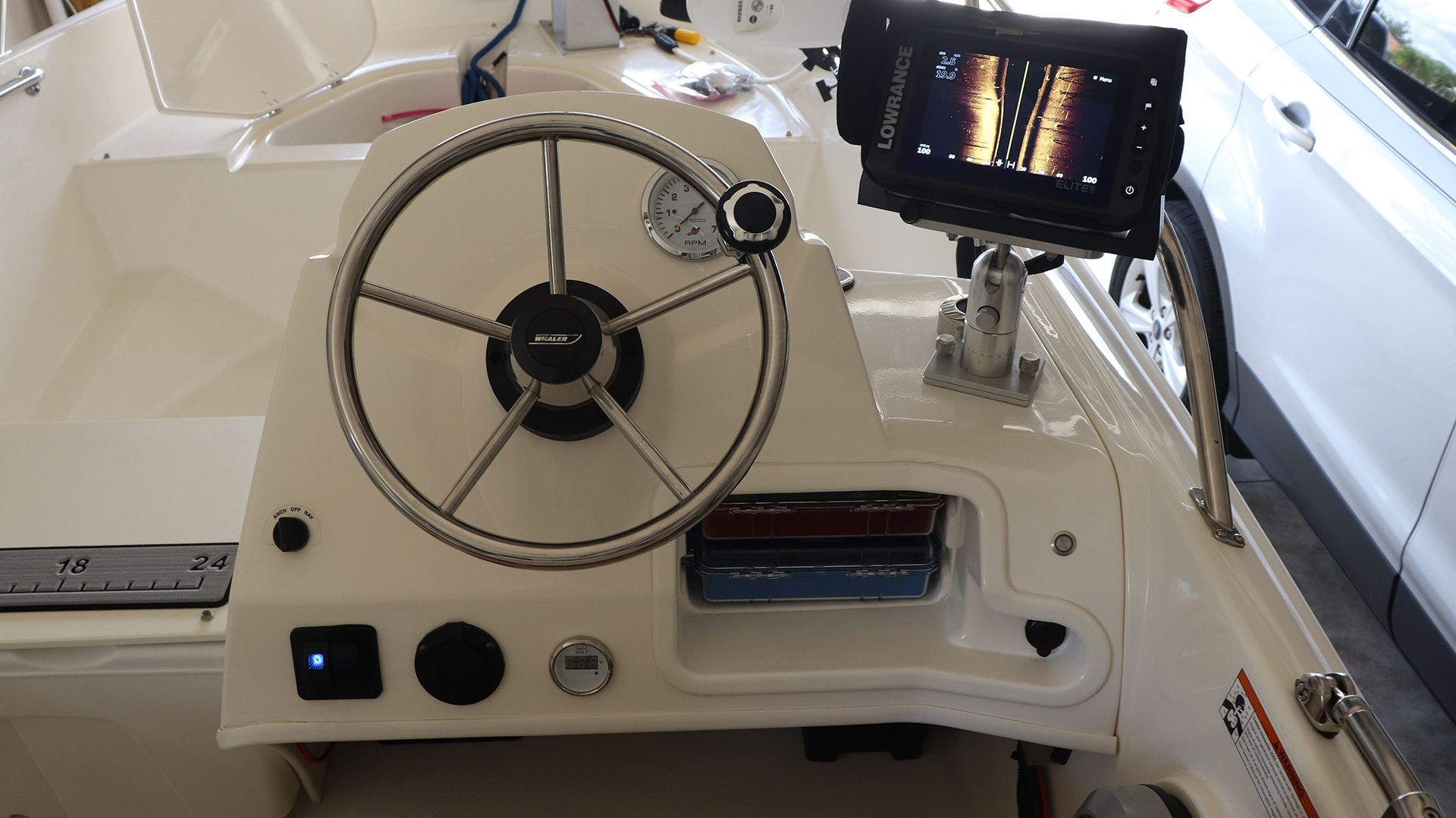The image shows the helm of a 2018 Boston Whaler 150 Super Sport with a Lowrance fishfinder.