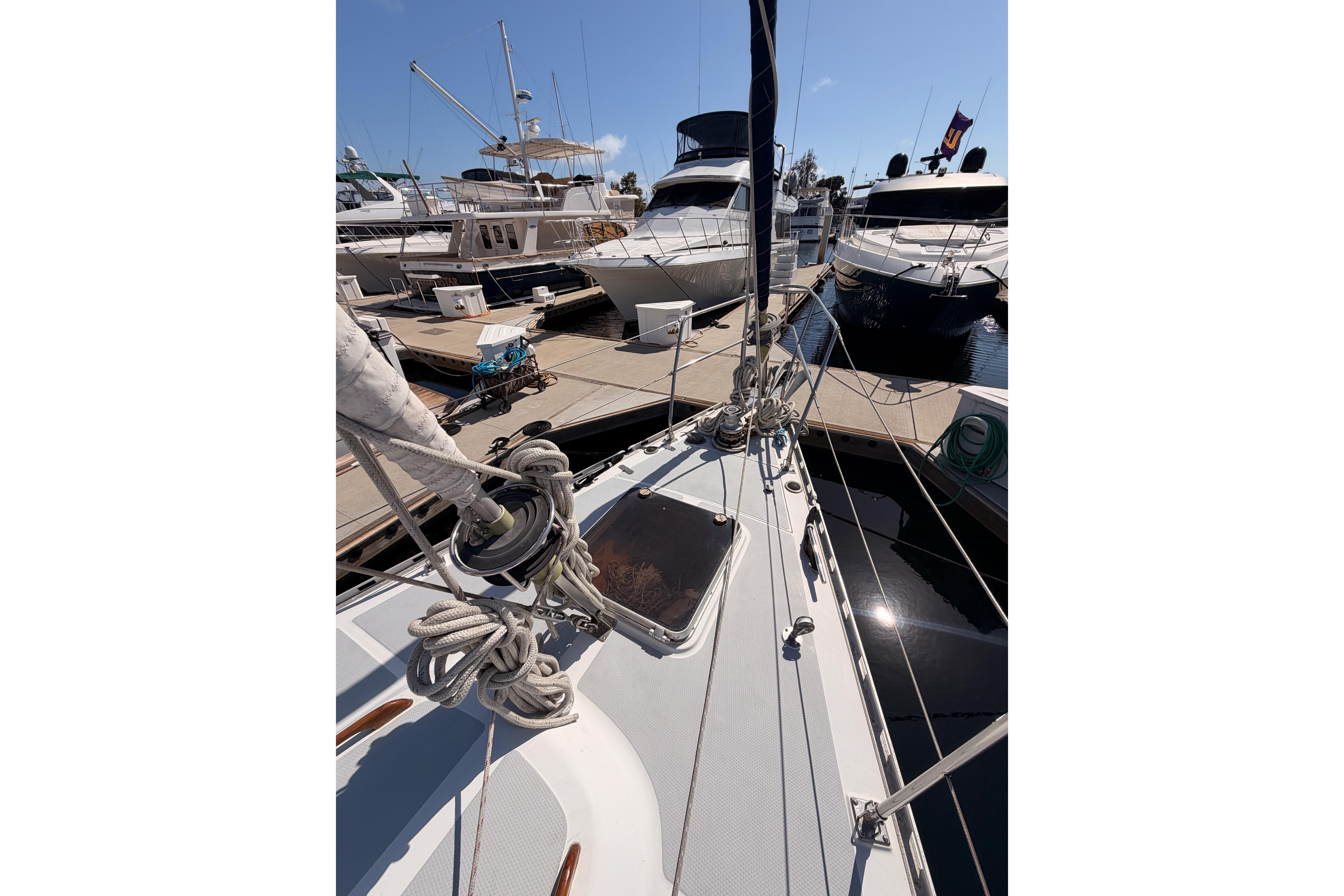 Sailboat Hylas 51, 1991 model, docked at marina with other yachts.