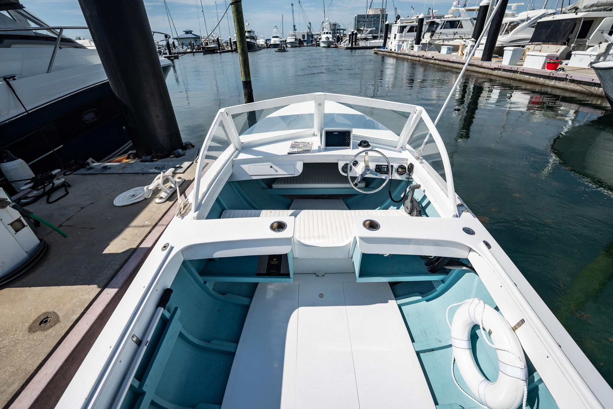 1982 Albury Brothers Runabout docked at marina, showcasing spacious interior and classic design.