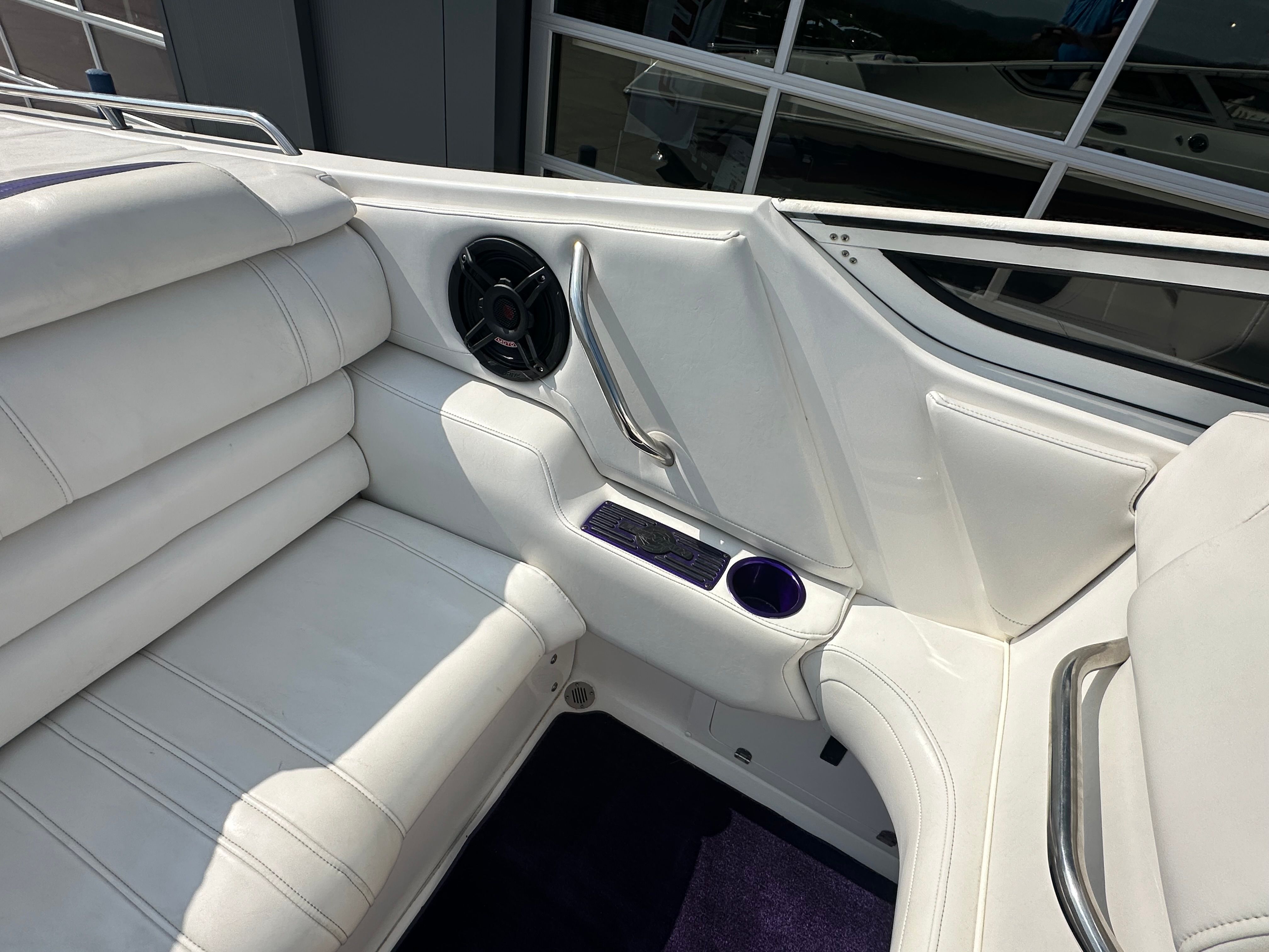 Interior of a 2006 Fountain 29 Fever with white upholstery and speaker.