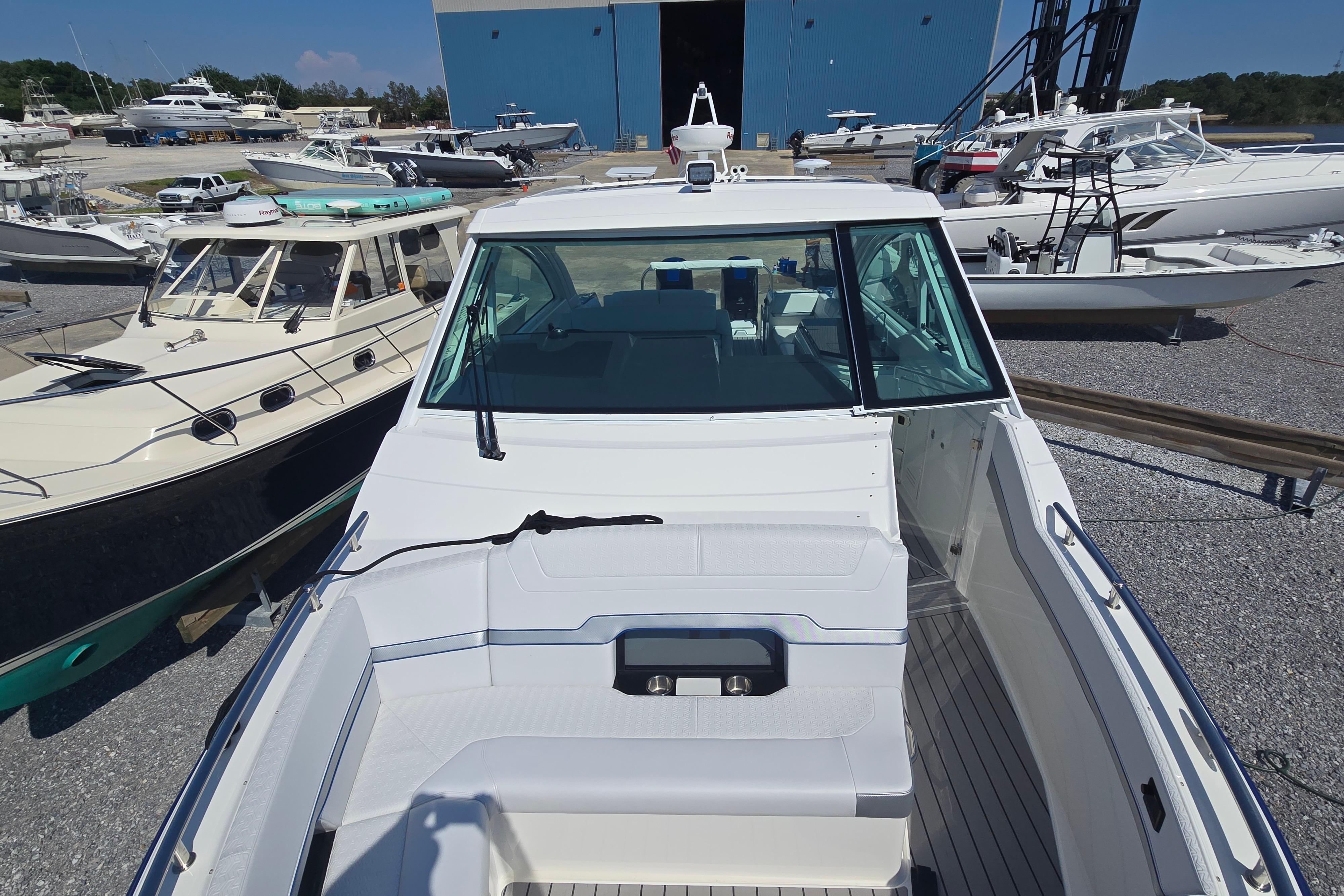 2025 Formula 380 Super Sport Crossover OB docked among other boats.