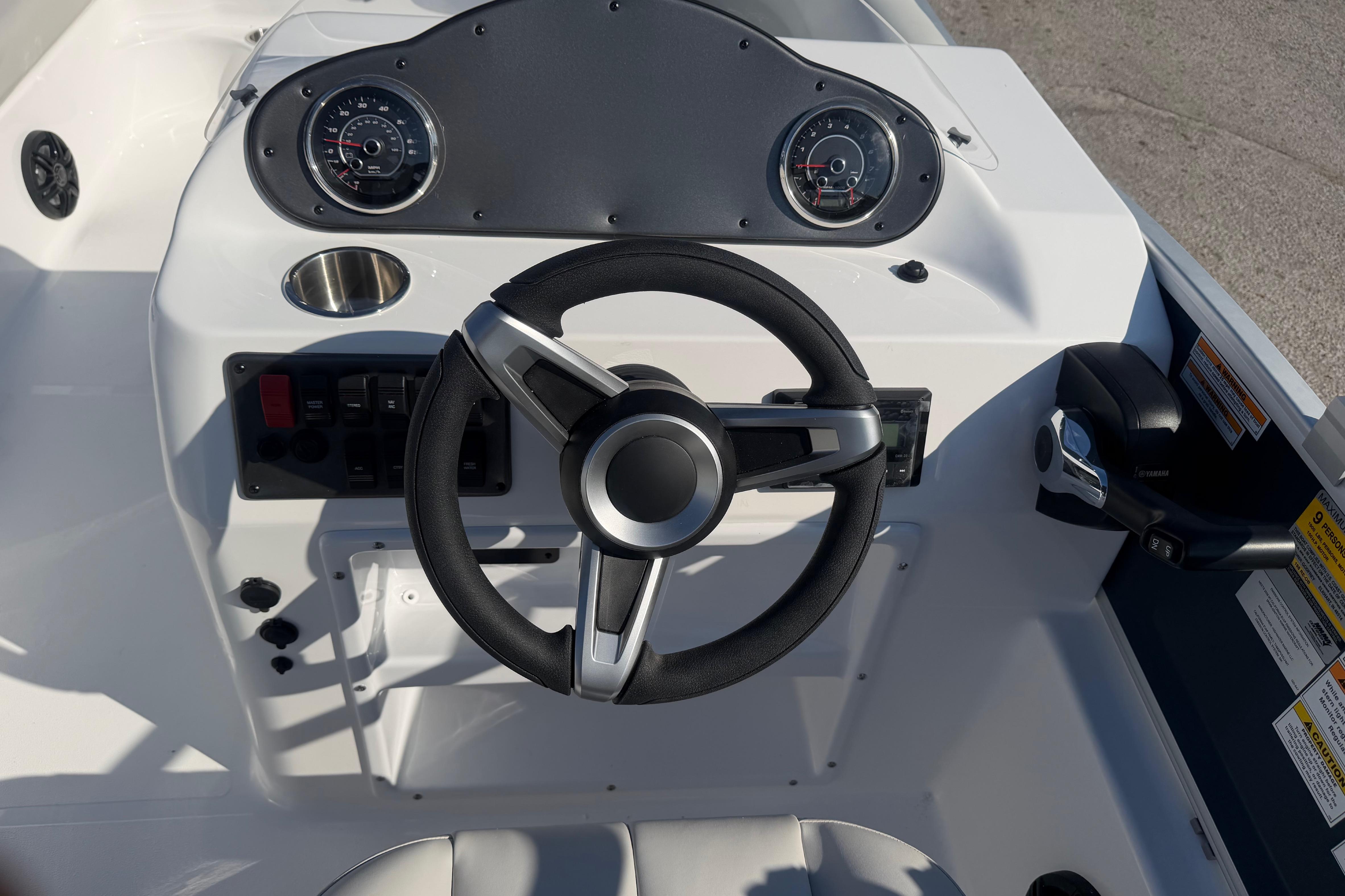 Steering console of 2026 Hurricane FunDeck 198 RE OB boat with gauges and controls.