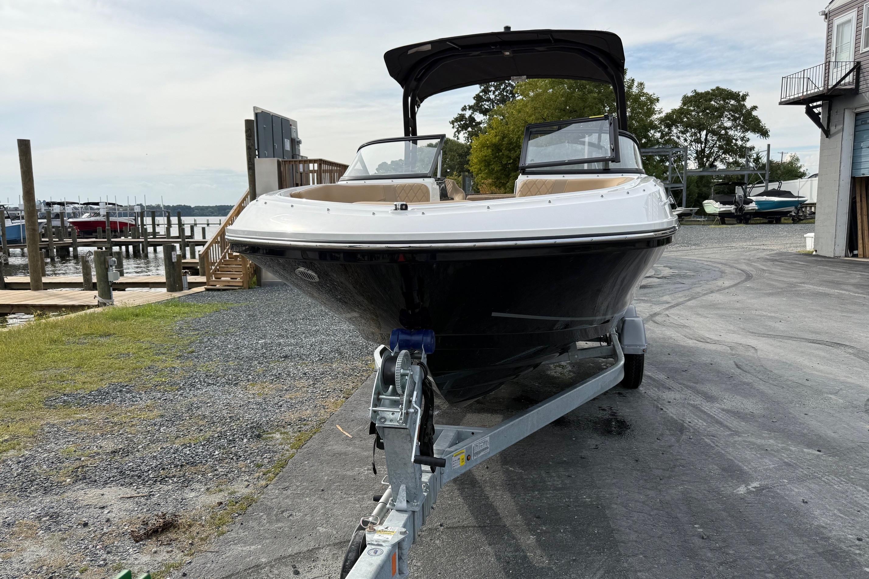 2026 Bayliner VR6 Bowrider OB on trailer at marina, ready for launch.
