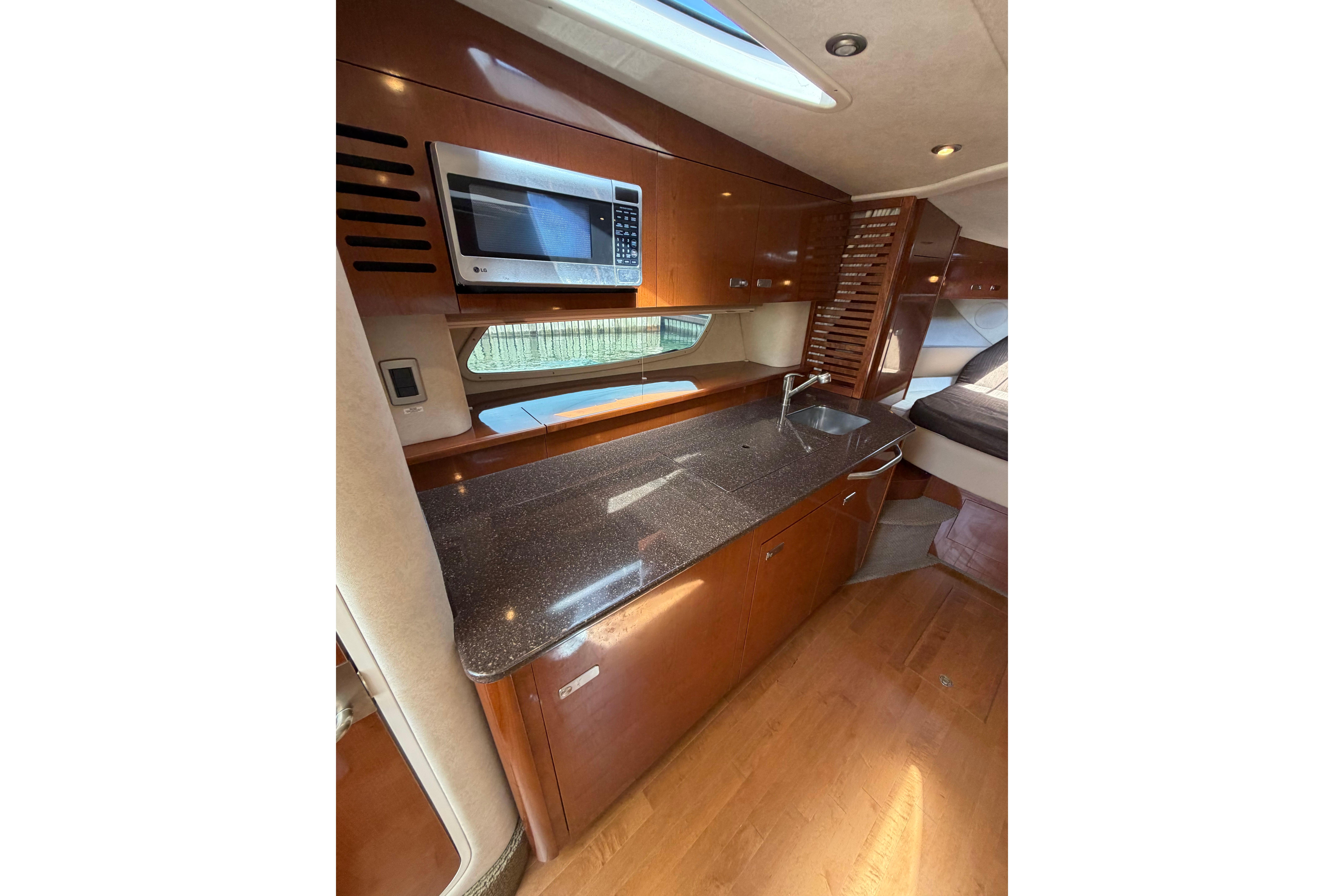 Interior of 2012 Sea Ray Sundancer 370 yacht with modern kitchen amenities.