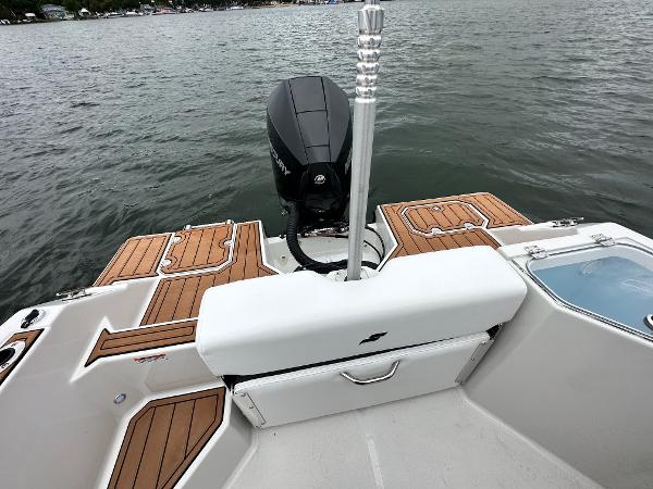 2025 Starcraft SVX 211 OB CC boat, rear view with motor and teak deck details.