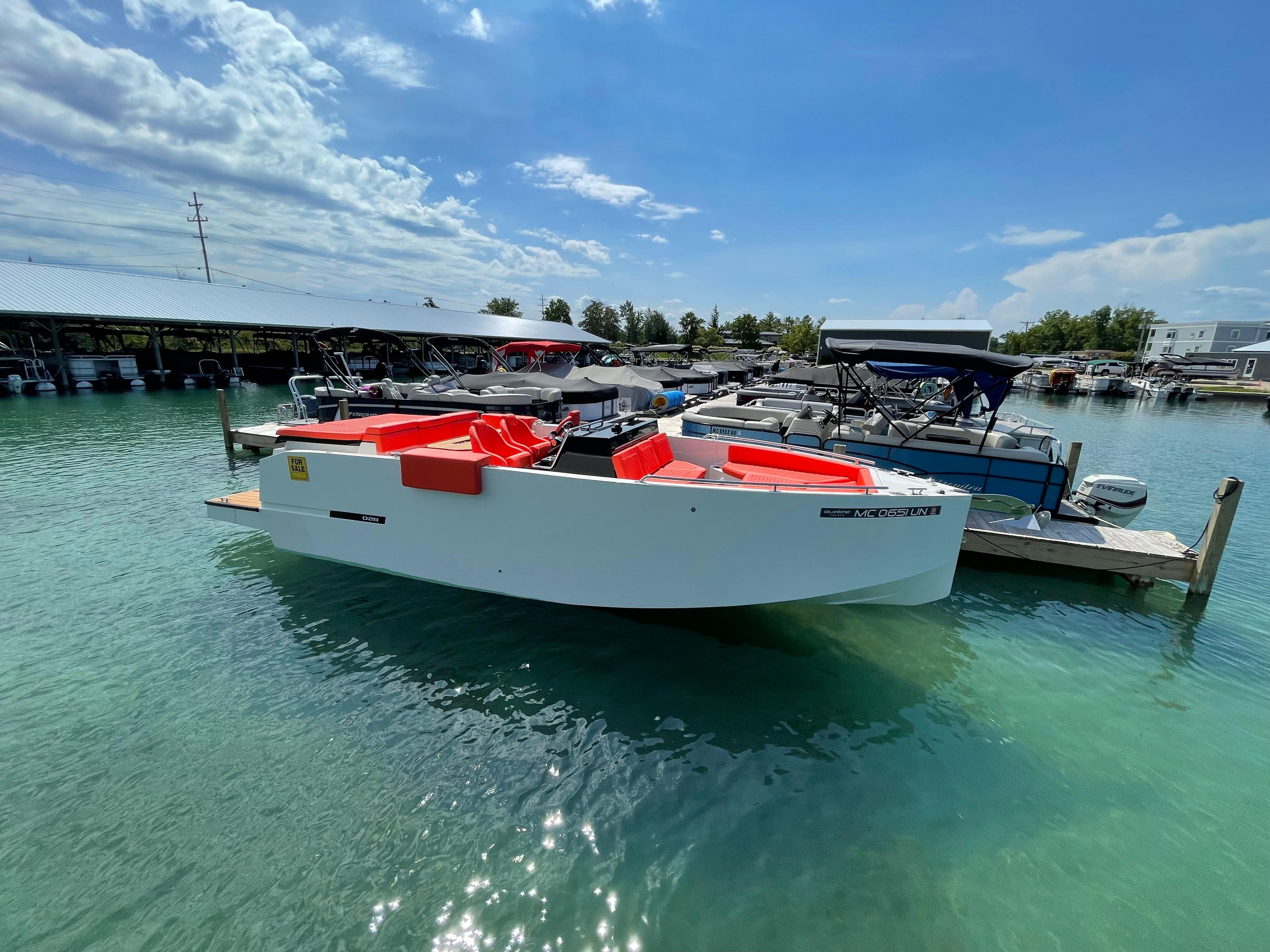 2020 De Antonio Yachts D 28 docked in clear water on a sunny day.