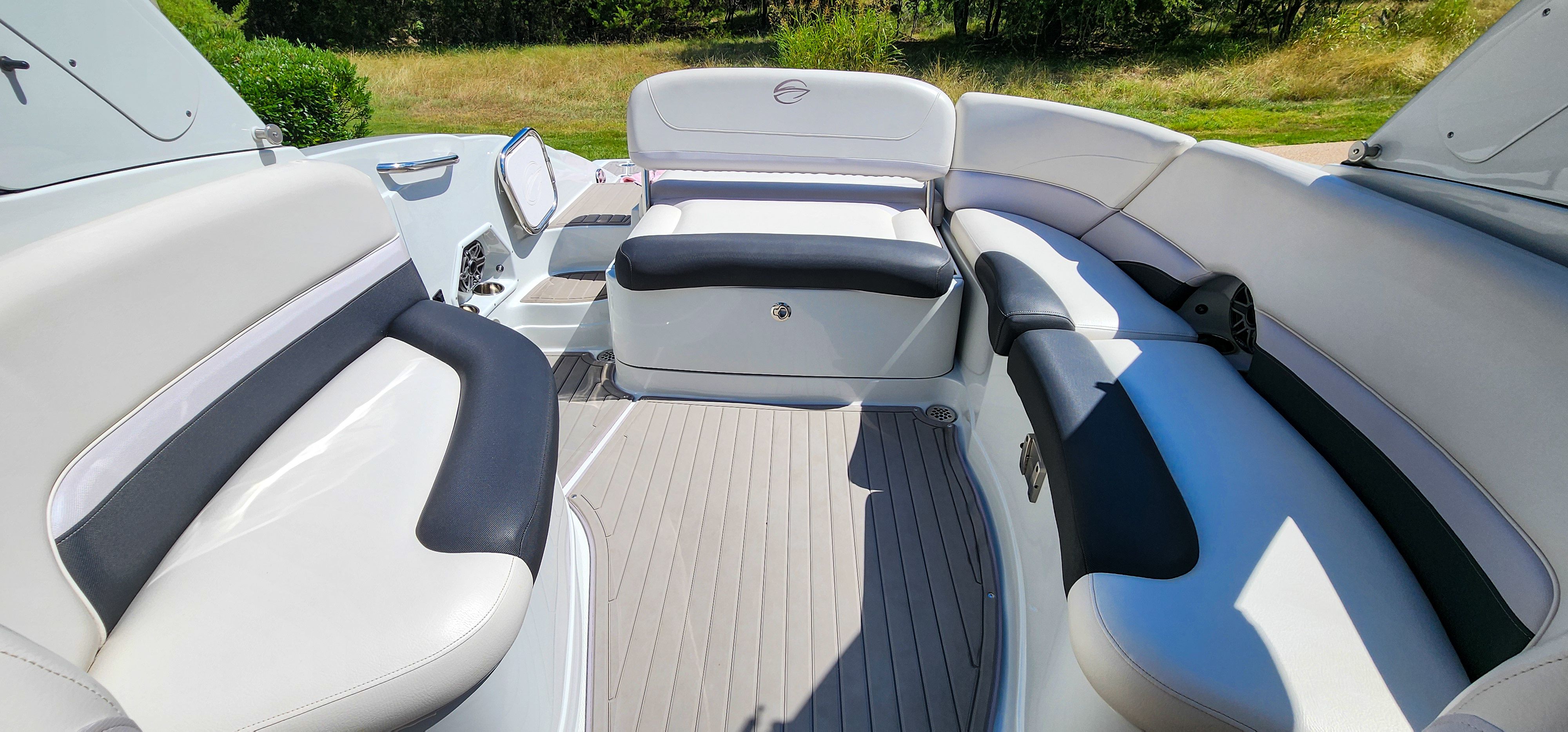 The image shows the cockpit of a 2017 Crownline 285SS boat with white and black seating.