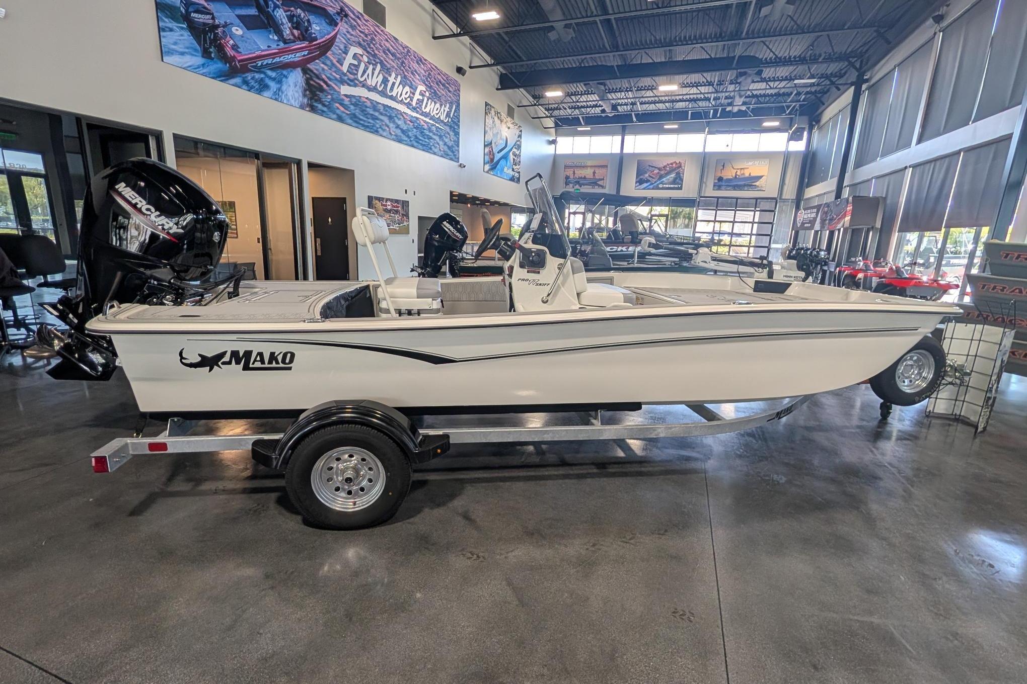 2026 Mako Pro Skiff 17 CC boat displayed in a showroom on a trailer.