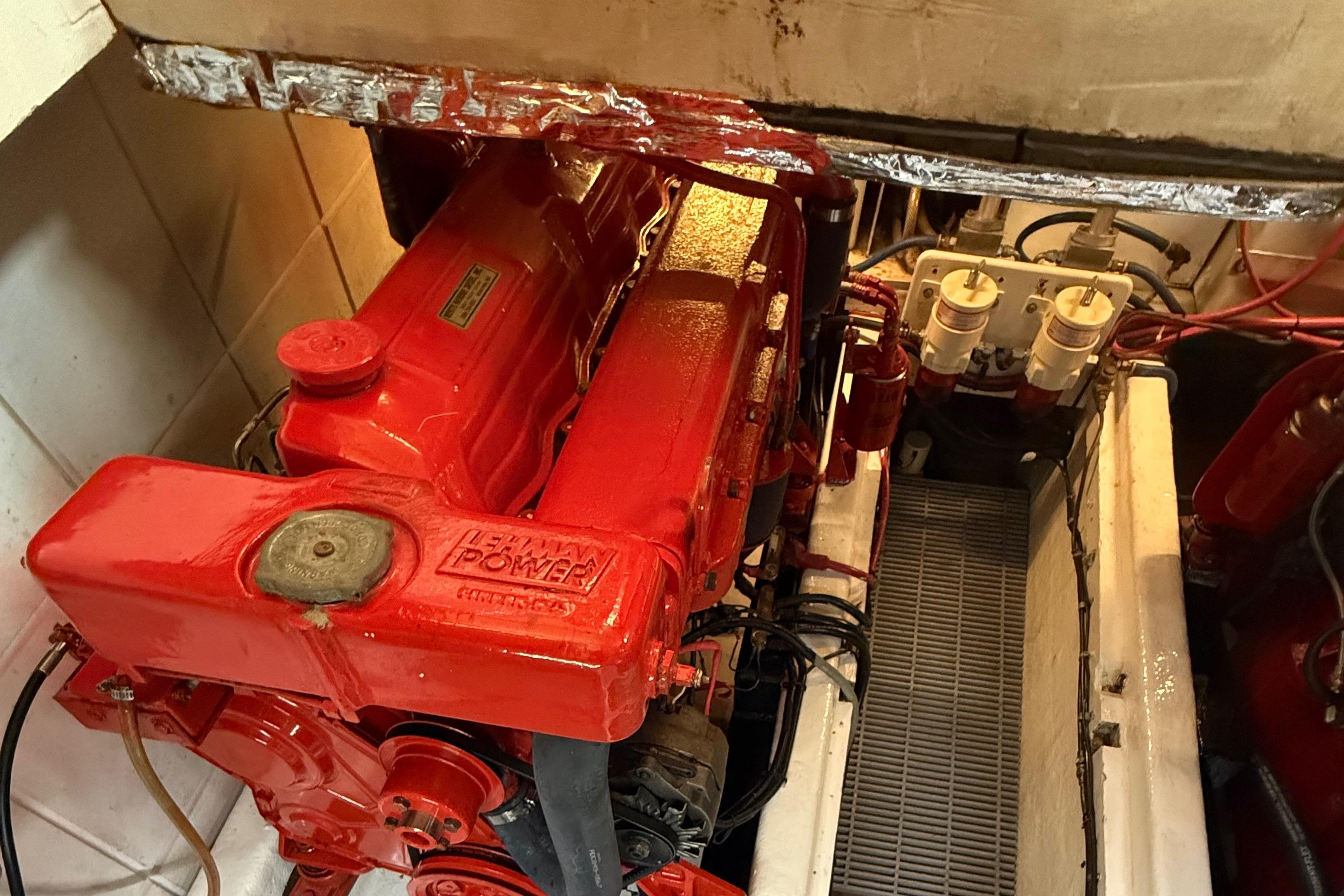 Engine room of a 1978 DeFever 39 boat with a red Lehman Power engine.