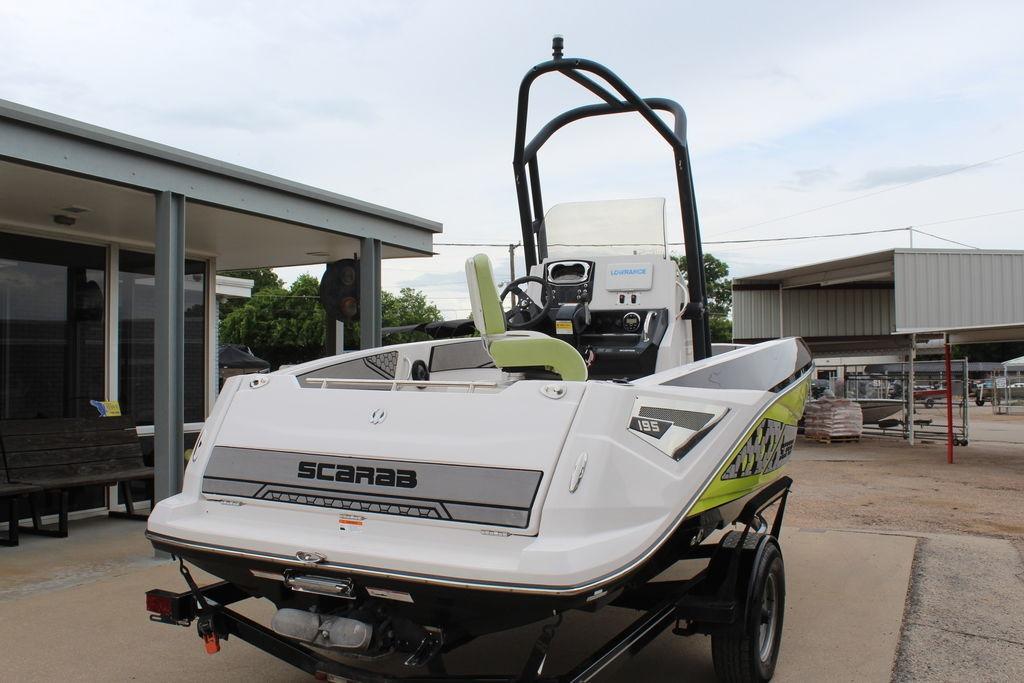 2017 Scarab 195 boat on trailer, parked outdoors near buildings.