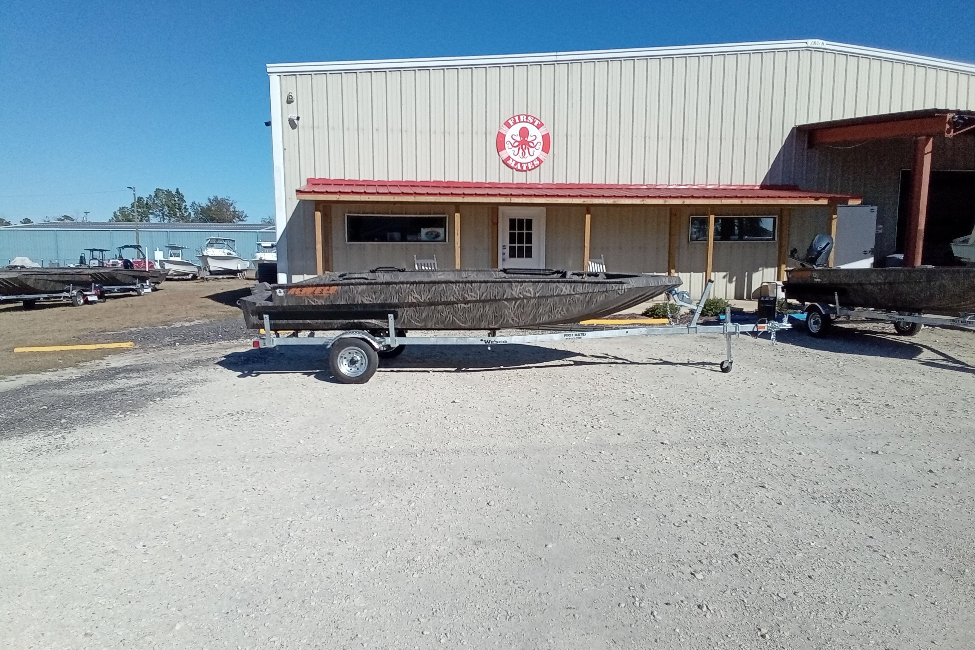2026 Alweld 1756 Invader boat on trailer outside a metal building.