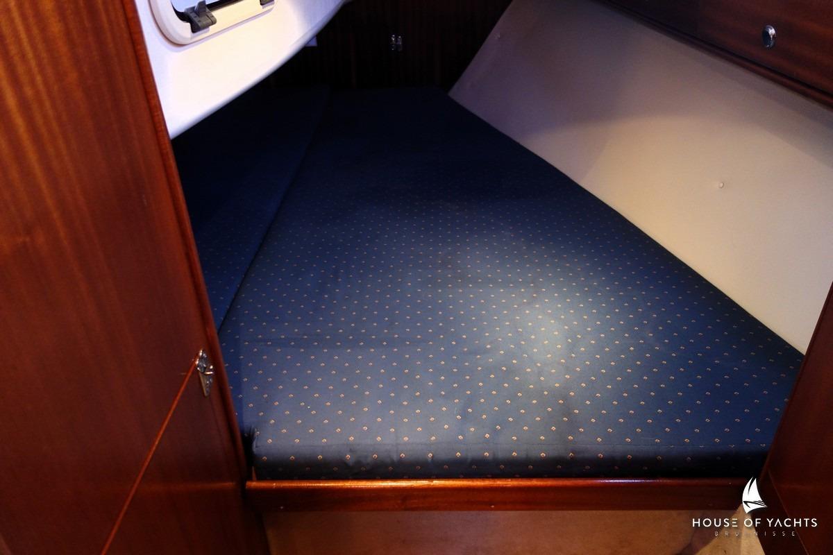 Cozy cabin interior of 2003 Bavaria 32 yacht with blue polka dot mattress.