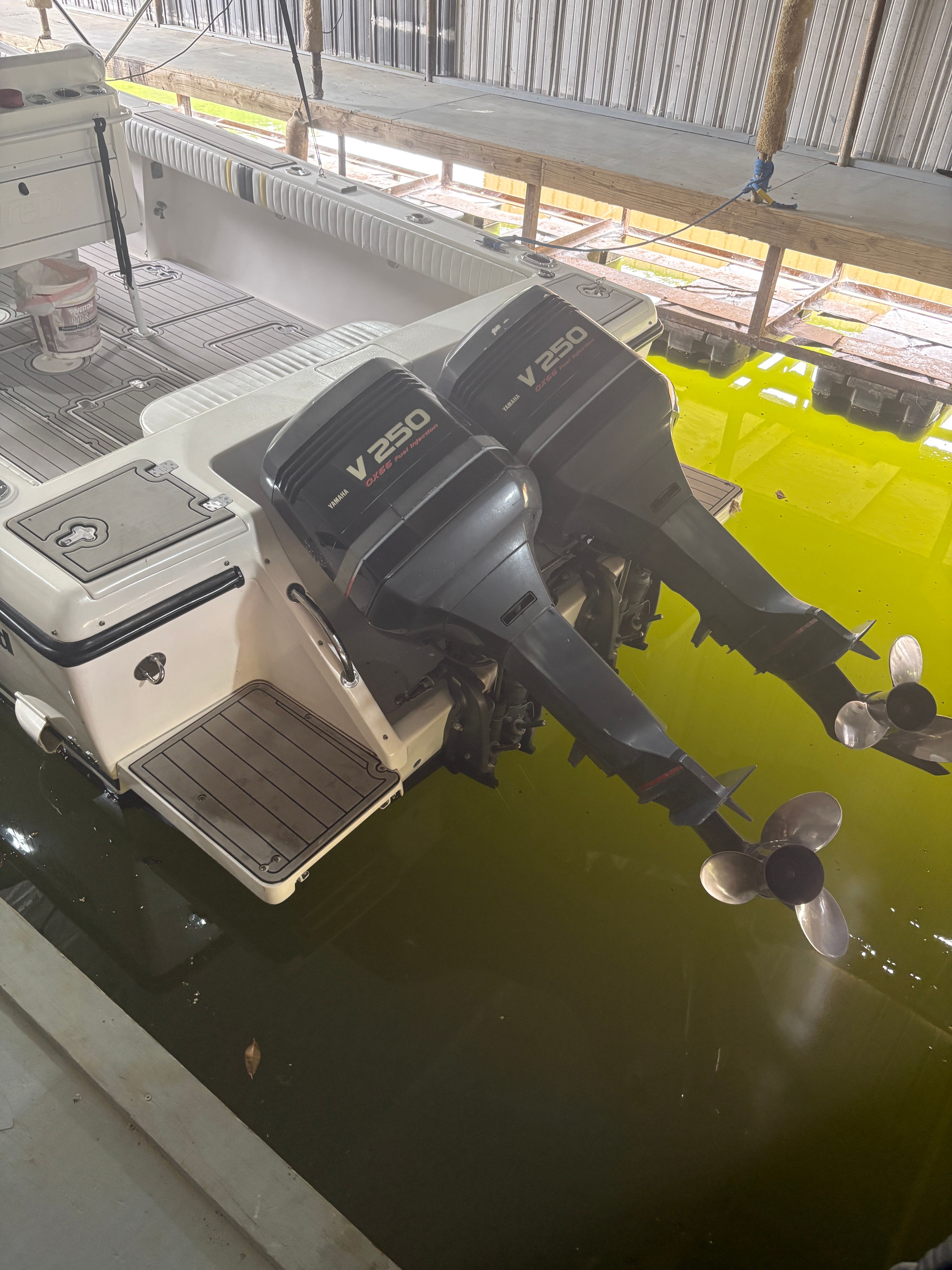 Intrepid 322 Cuddy Center Console boat with twin V250 engines in water.