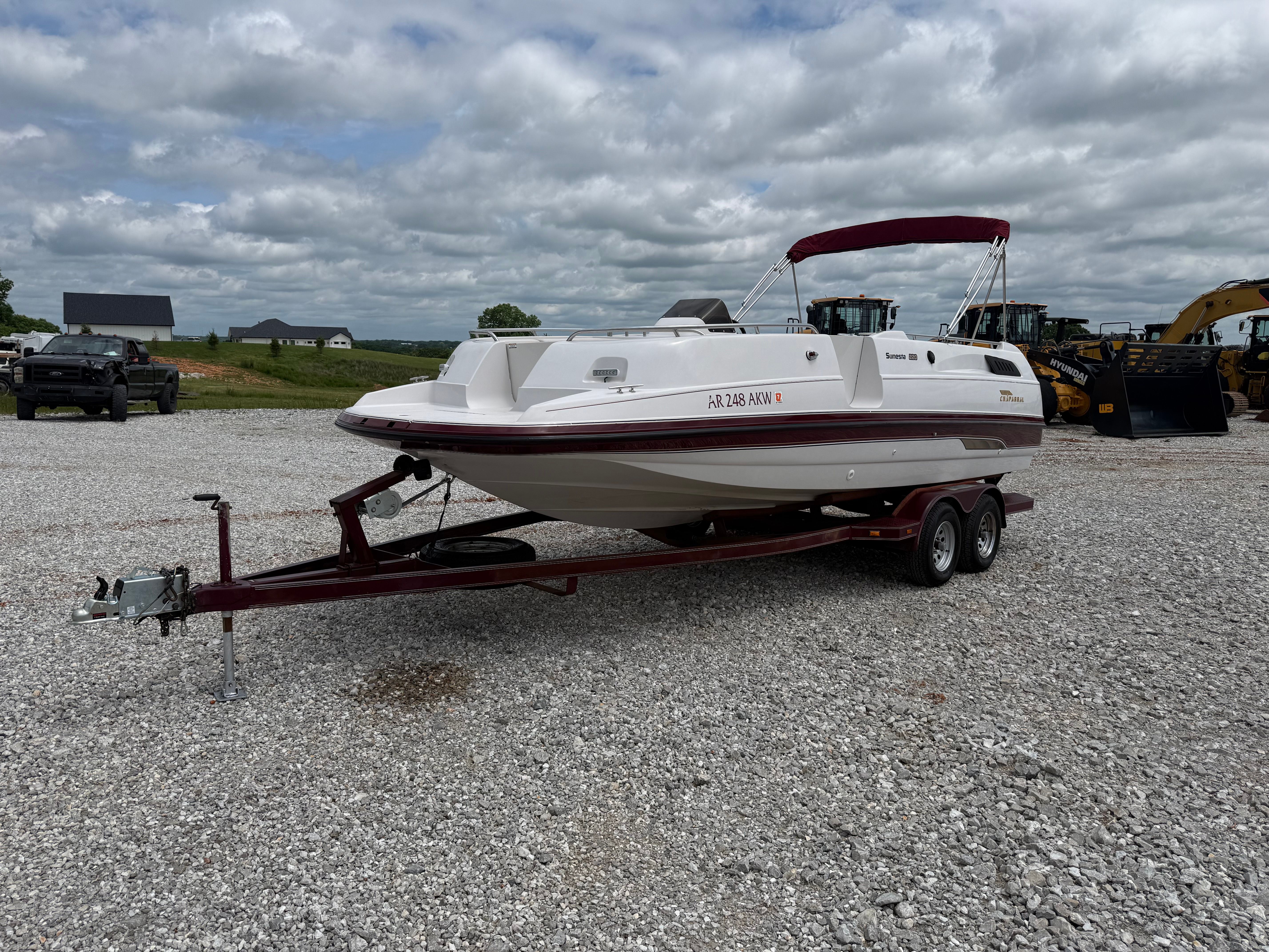 A 1994 Chaparral Sunesta 220 on a trailer in a gravel lot.