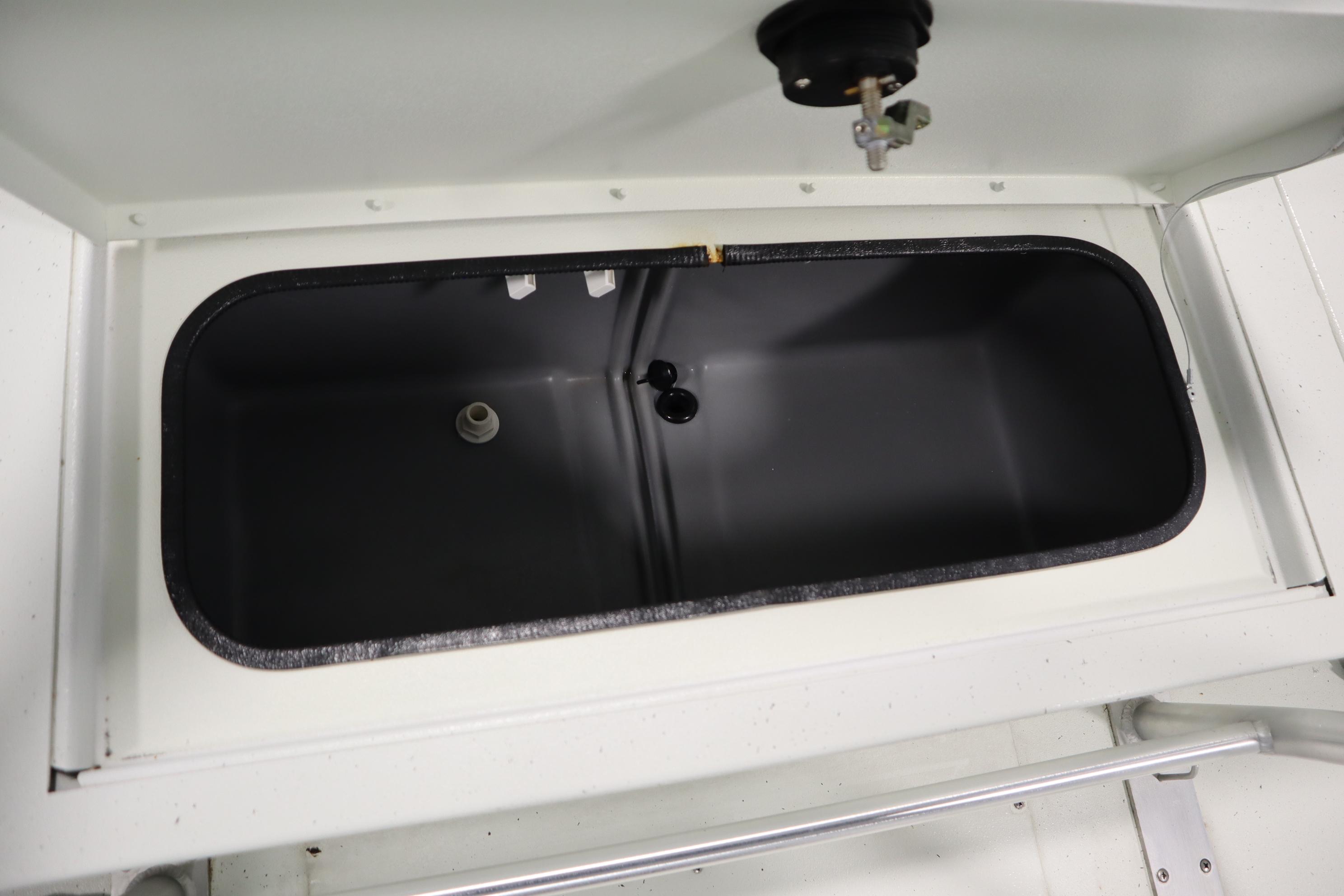 Livewell compartment in 2022 Crestliner 2200 CC boat, open lid view.