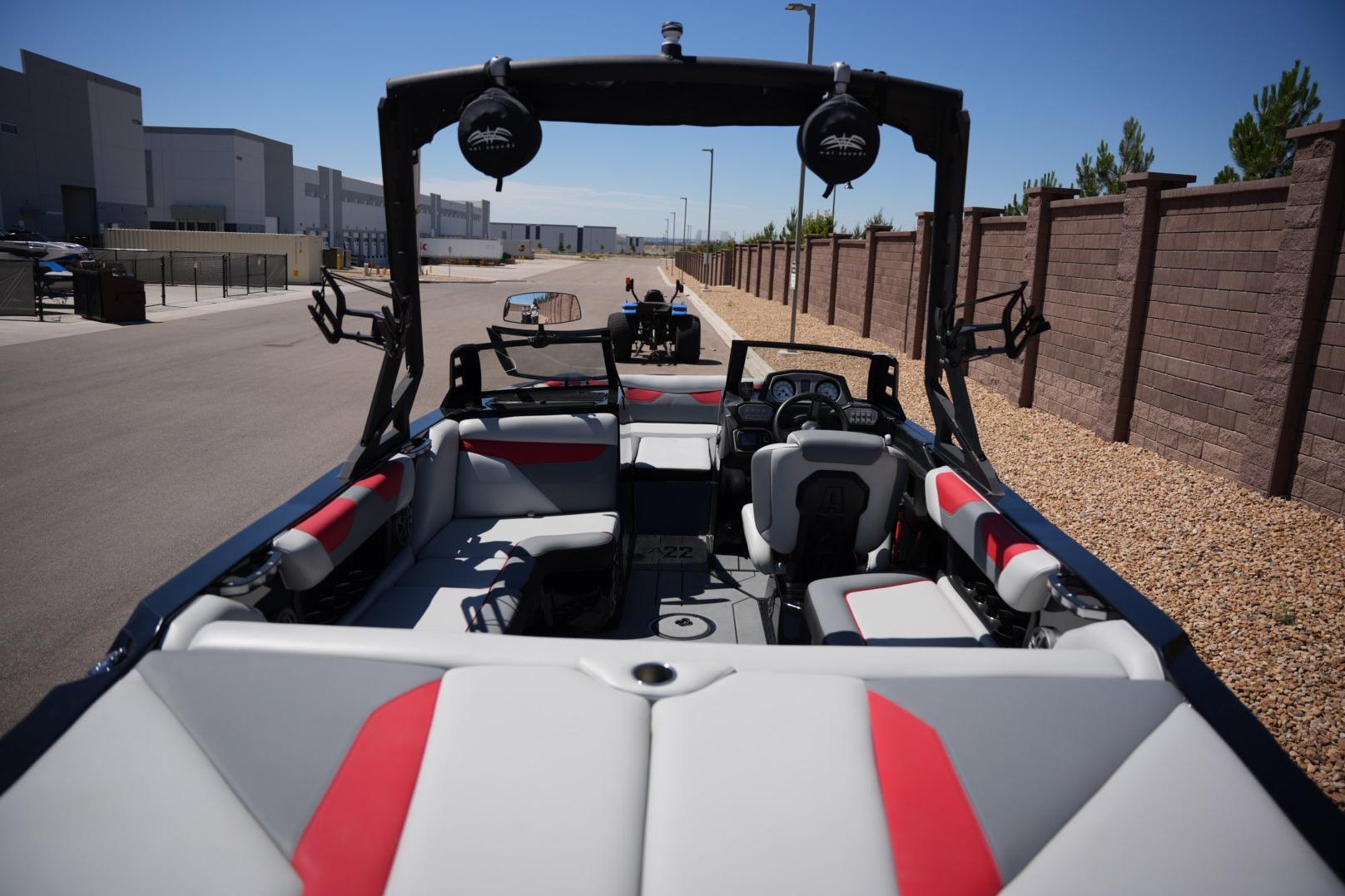 2019 Axis A22 boat interior with red and gray seating, parked outdoors.