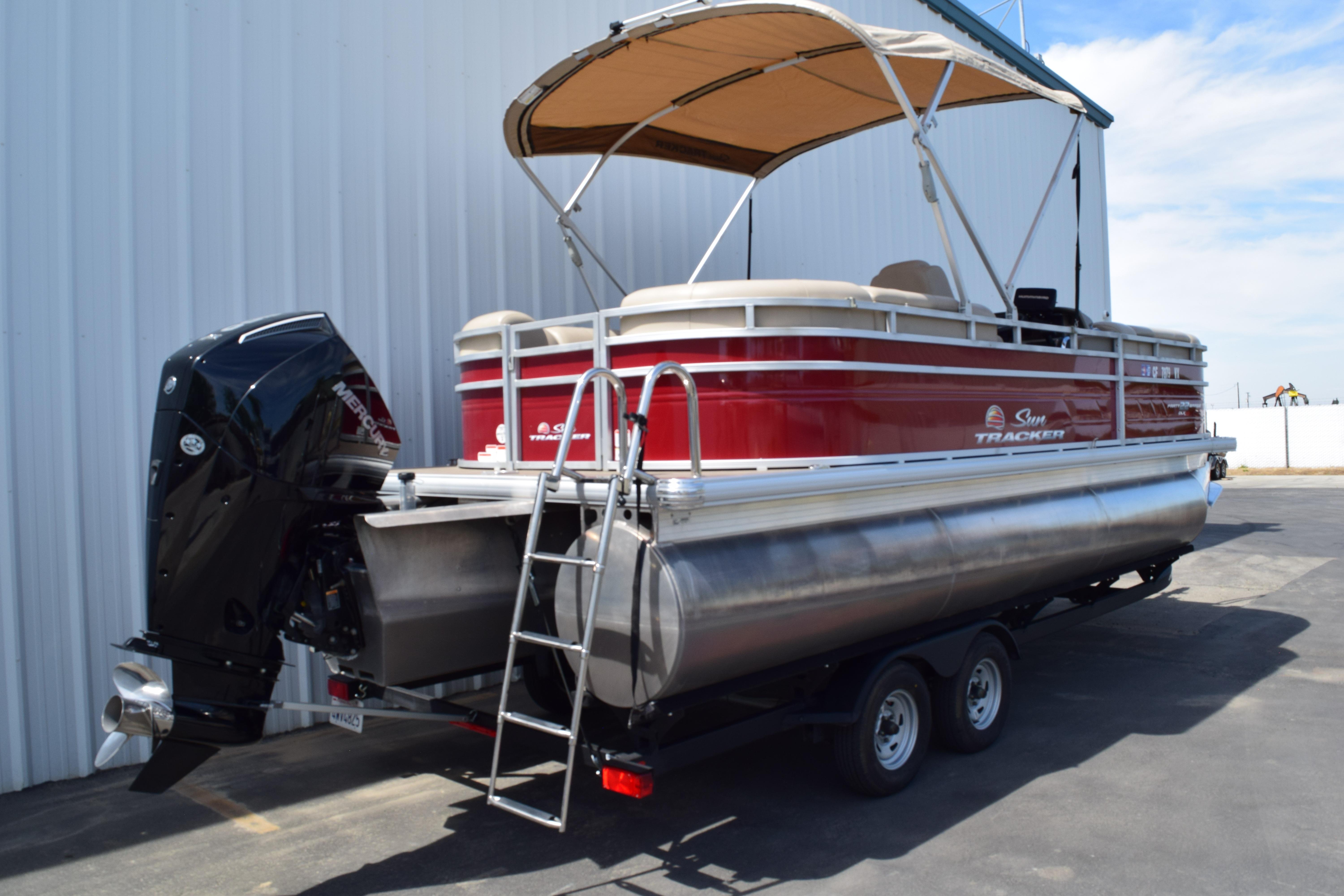 2025 Sun Tracker Party Barge 22 XP3 pontoon boat with canopy and outboard motor.