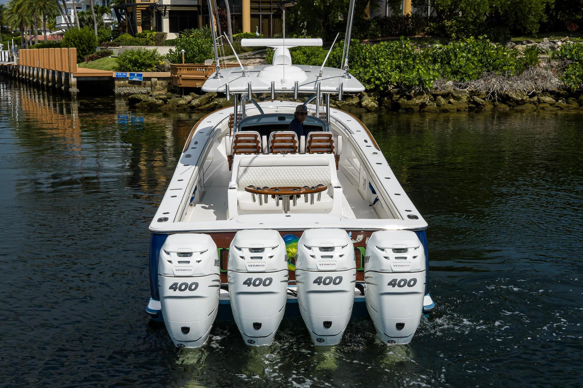 2020 Valhalla Boatworks V-41 with four powerful outboard engines cruising on a calm waterway.