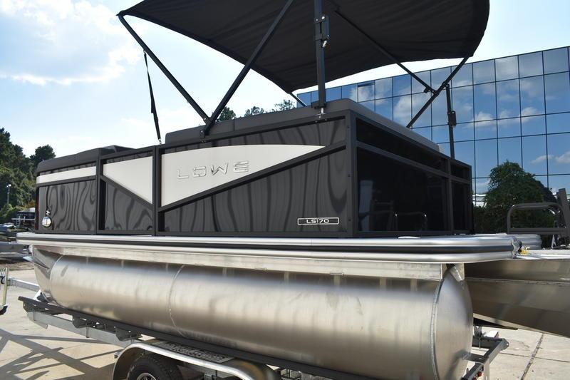 2026 Lowe LS 170 pontoon boat with canopy, displayed outdoors.