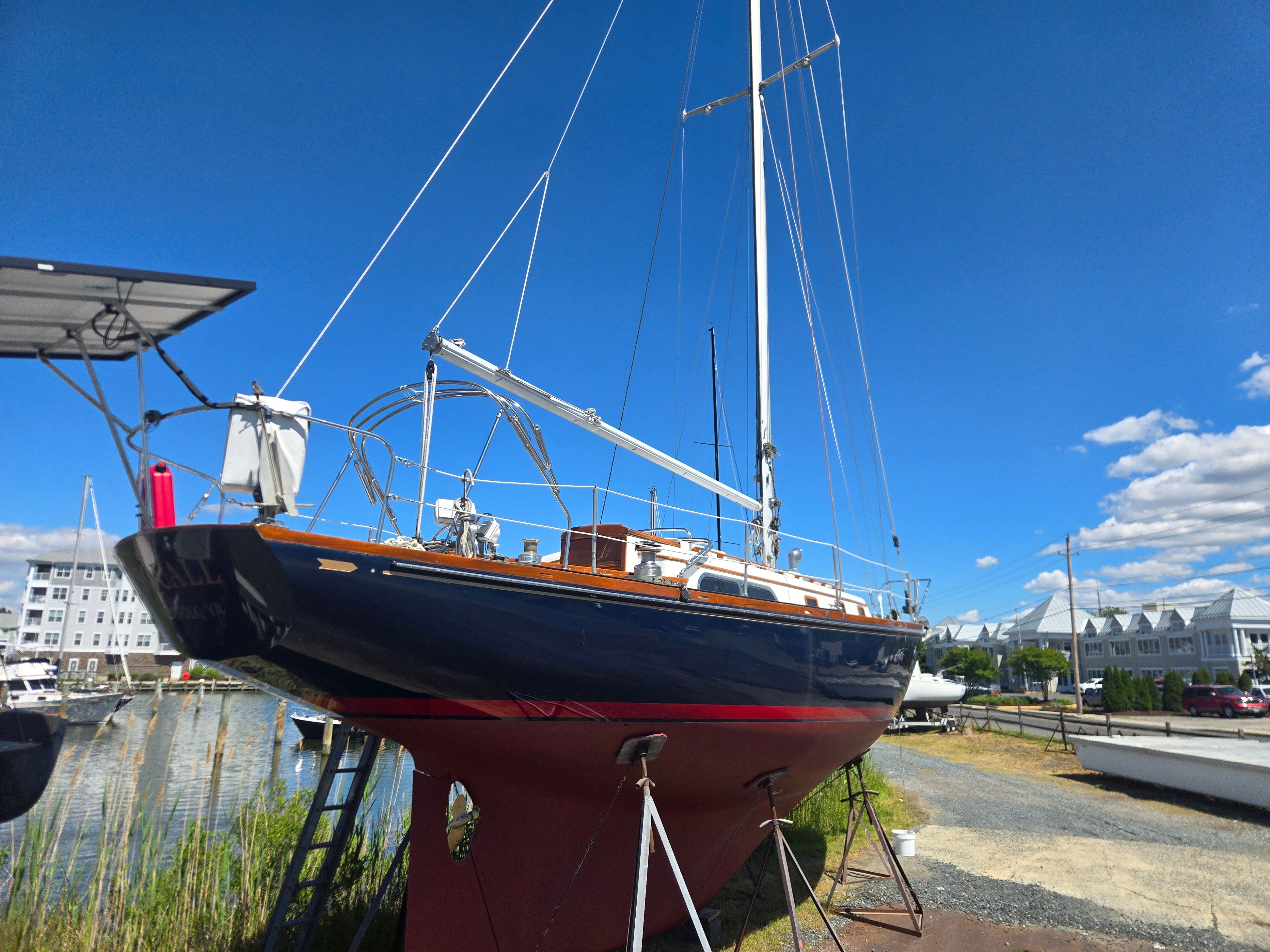 1969 Luders 36 sailboat on dry dock under clear blue sky.