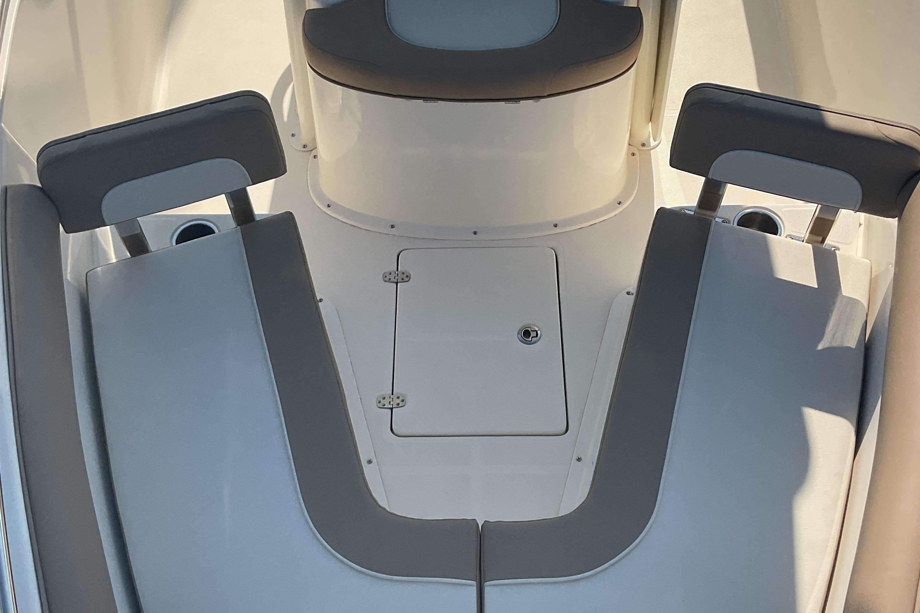 2023 Sea Born SX239 Offshore boat interior with cushioned seating and storage compartment.
