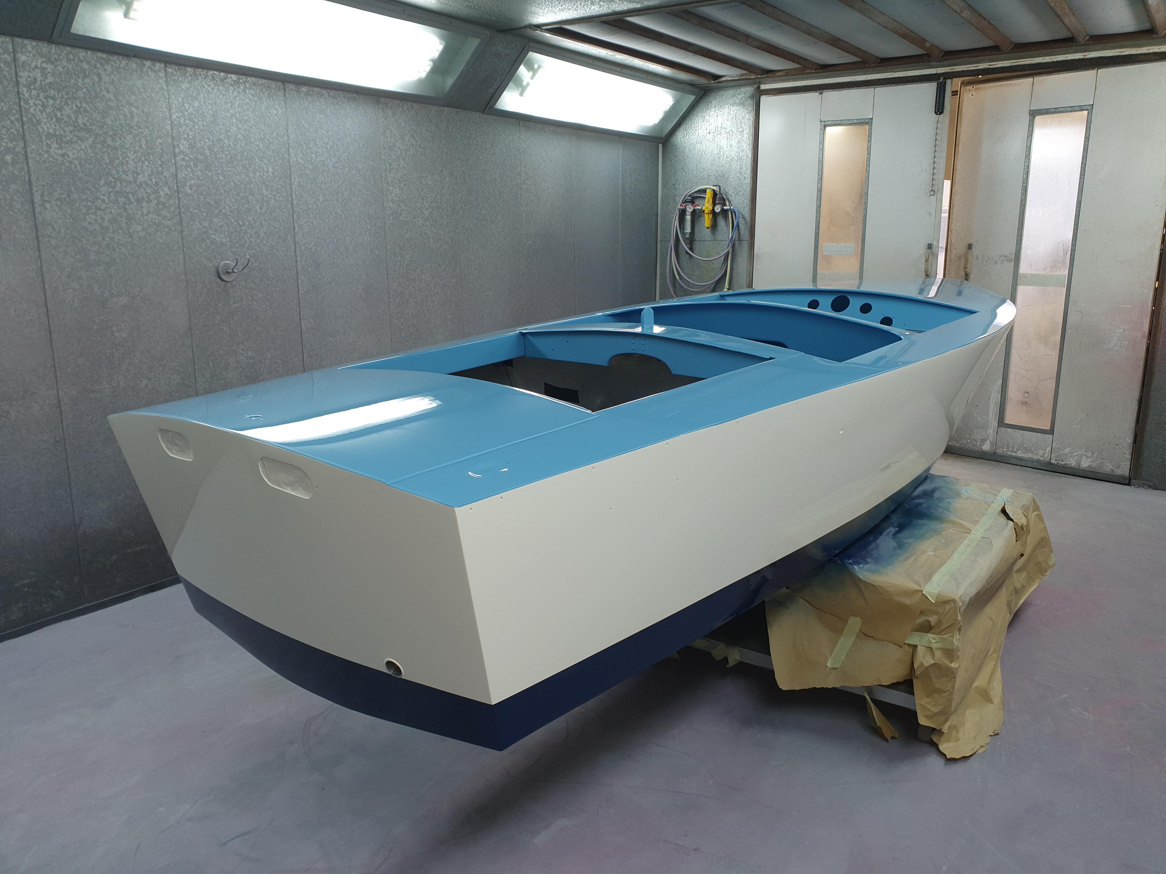 1963 Albatross Continental Mark II boat in a workshop, featuring a blue and white color scheme.