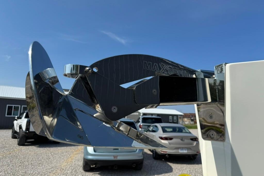 Shiny anchor on De Antonio Yachts D28, 2020 model, with clear blue sky background.