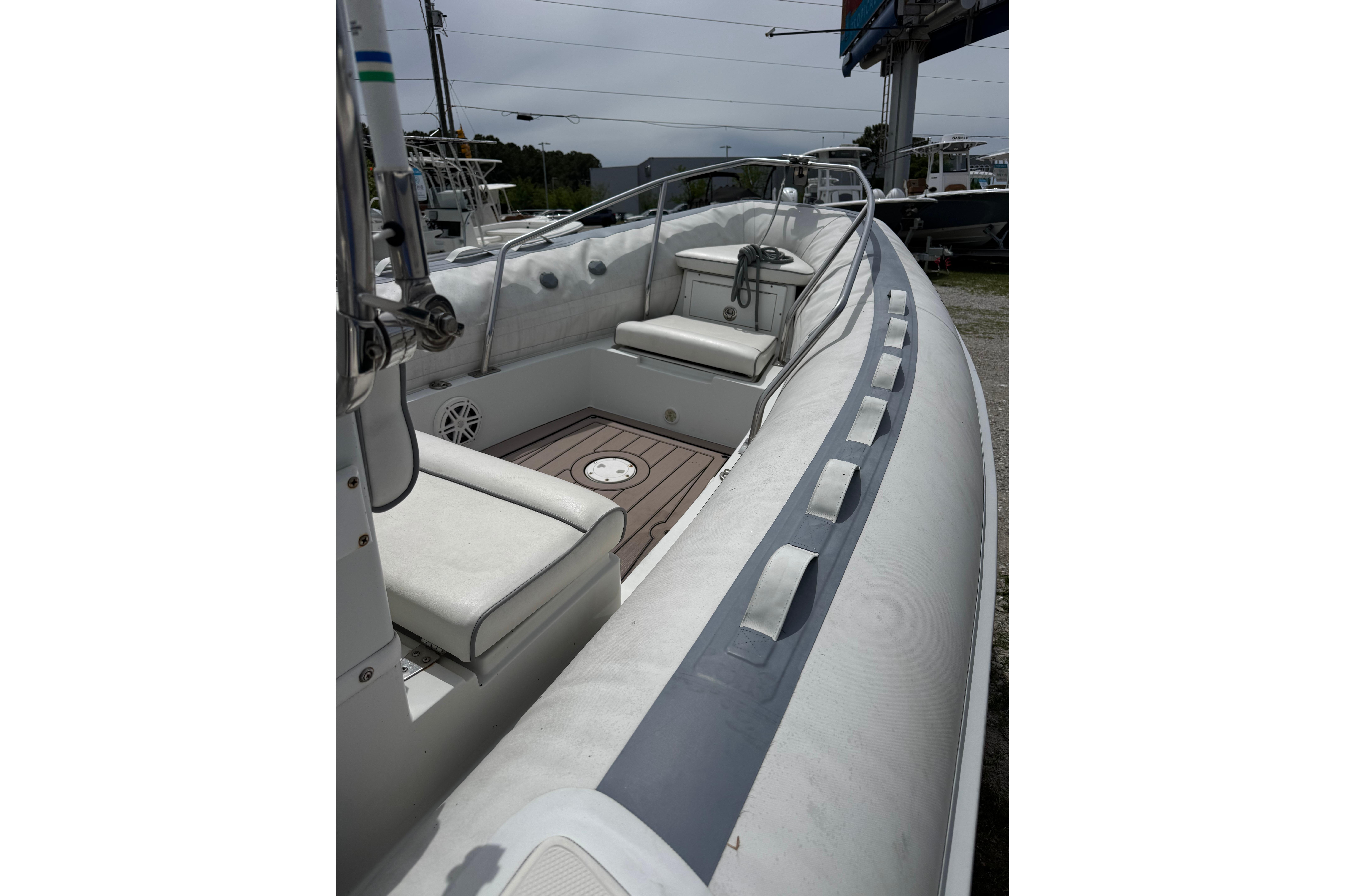 2002 Novurania 17 boat interior with white seating and wooden deck.
