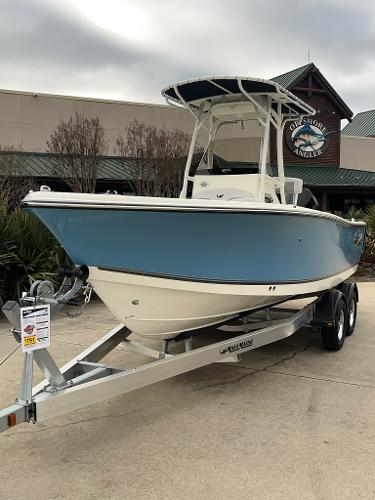 2024 Mako 214 CC boat on a trailer outside a dealership.