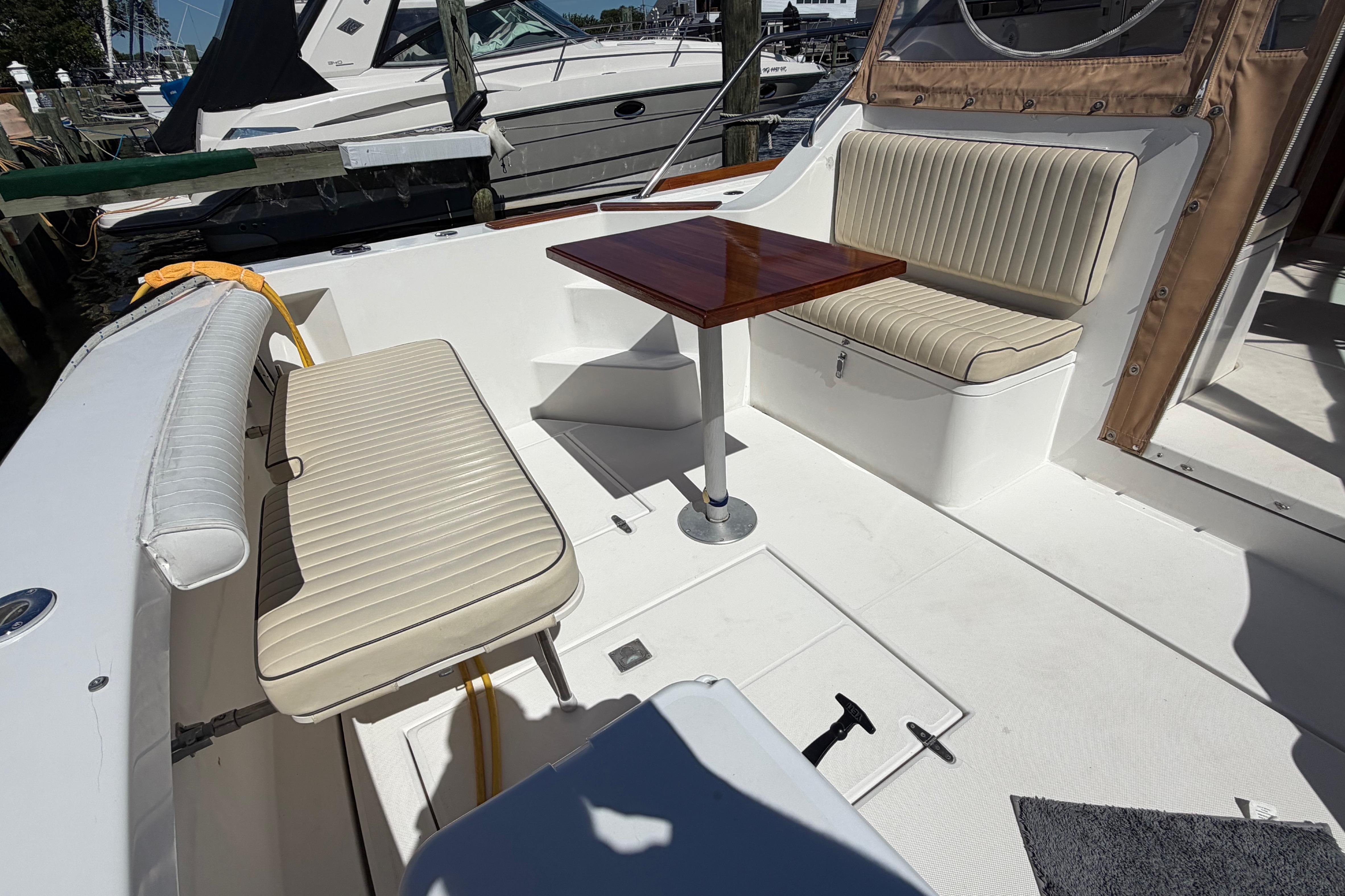 2000 Sabreline 36 Express boat interior with cushioned seating and wooden table.