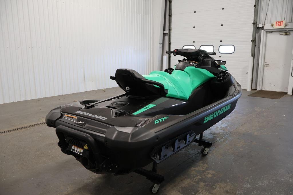 2026 Sea-Doo GTI SE 130 jet ski in a garage, showcasing sleek design and vibrant colors.