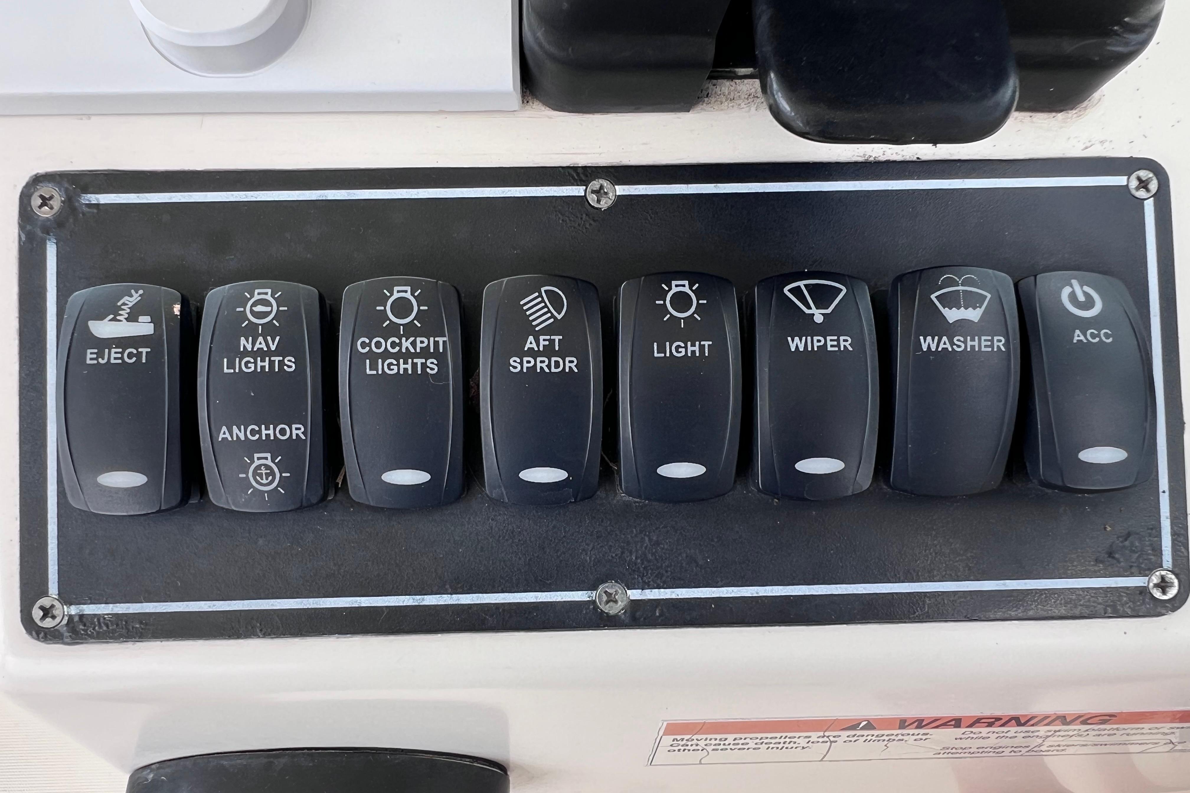 Control panel of a 2005 Pursuit 3070 Offshore boat with labeled switches.