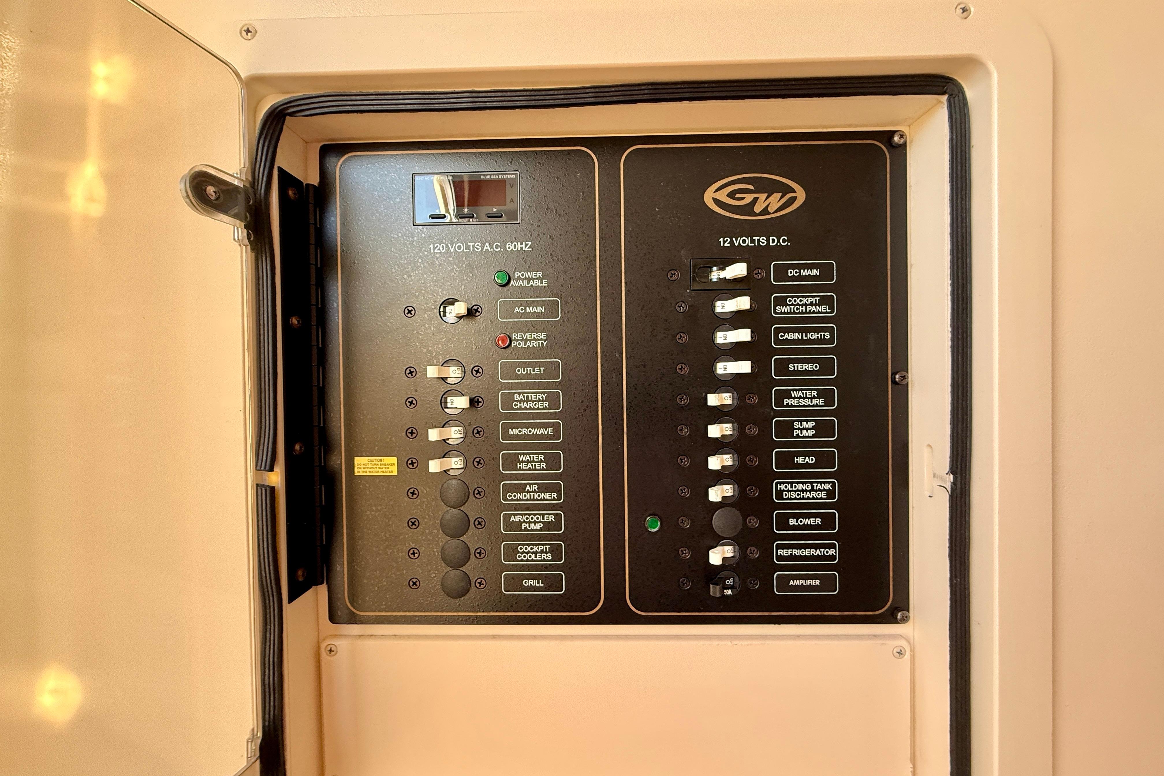 Electrical panel of 2012 Grady-White Canyon 336 boat, featuring AC and DC switches.
